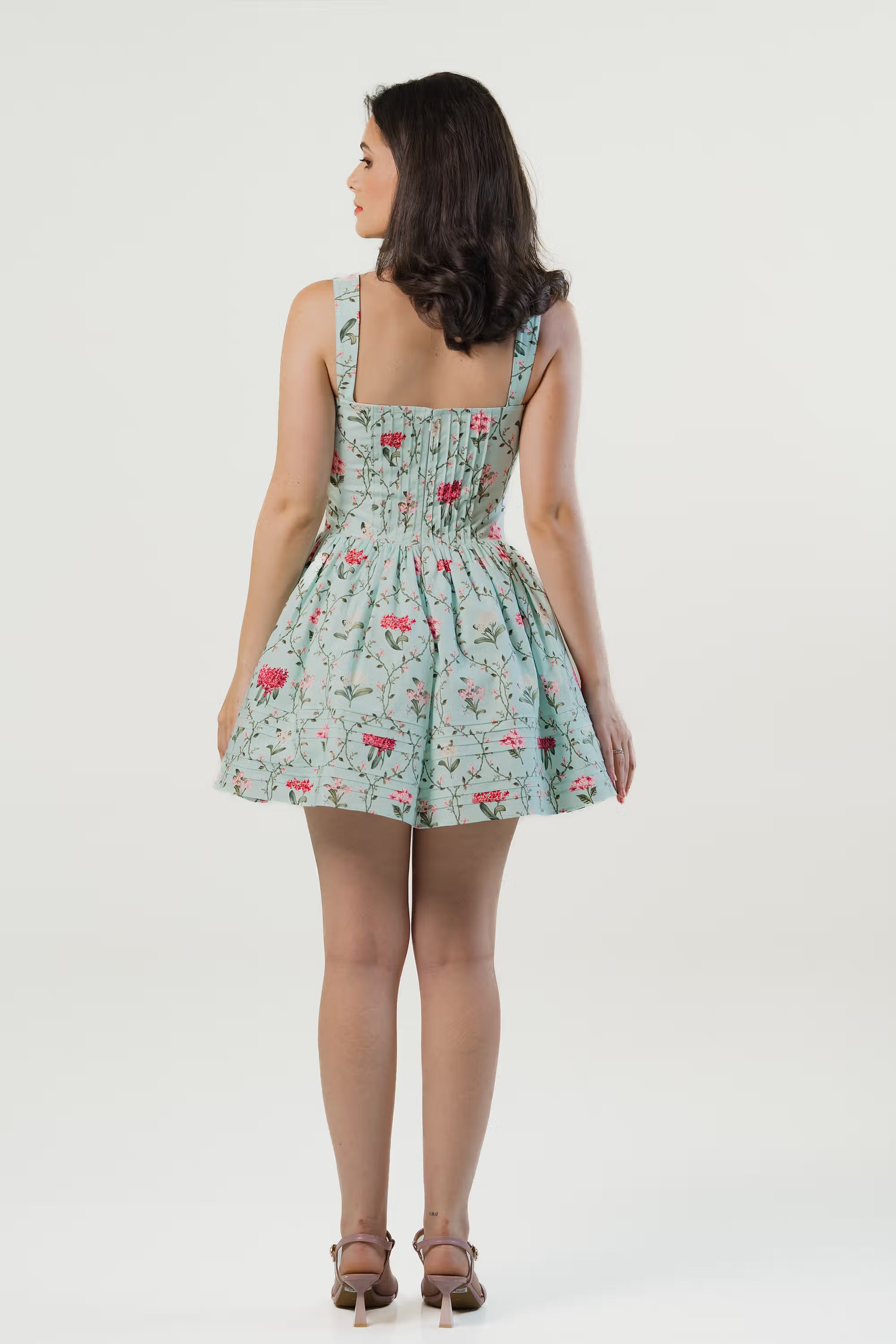 Full back view of mint green floral mini dress with square neckline and flared skirt