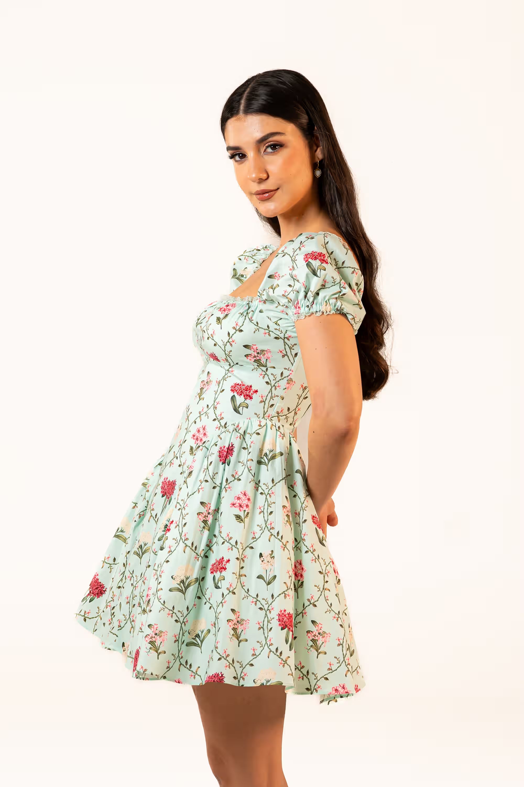 Over-the-shoulder look of model in mint green floral puff sleeve mini dress