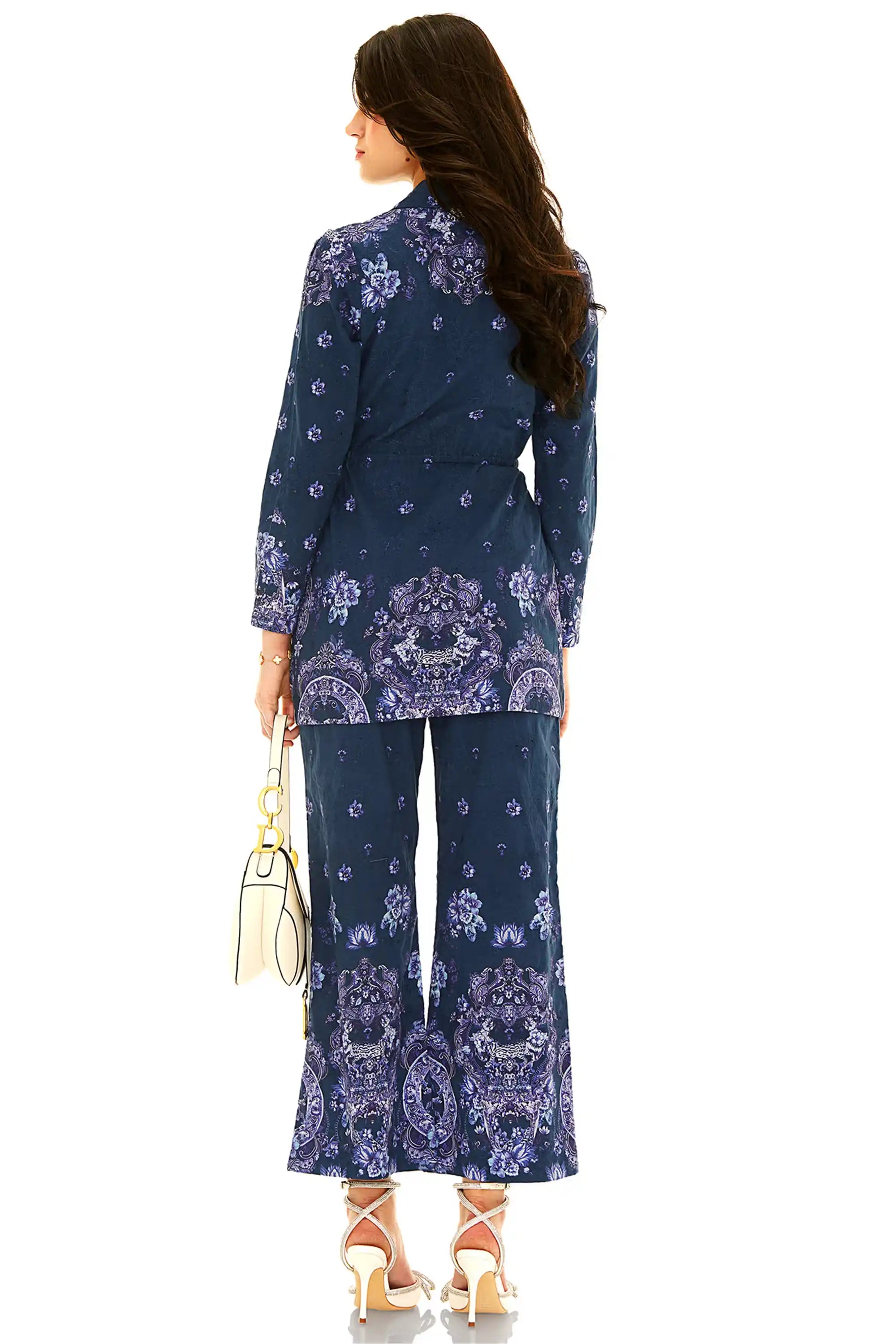 Back view of navy blue floral coord set with printed shirt and flared pants