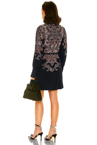 Back view of navy floral long sleeve mini dress with ornate print