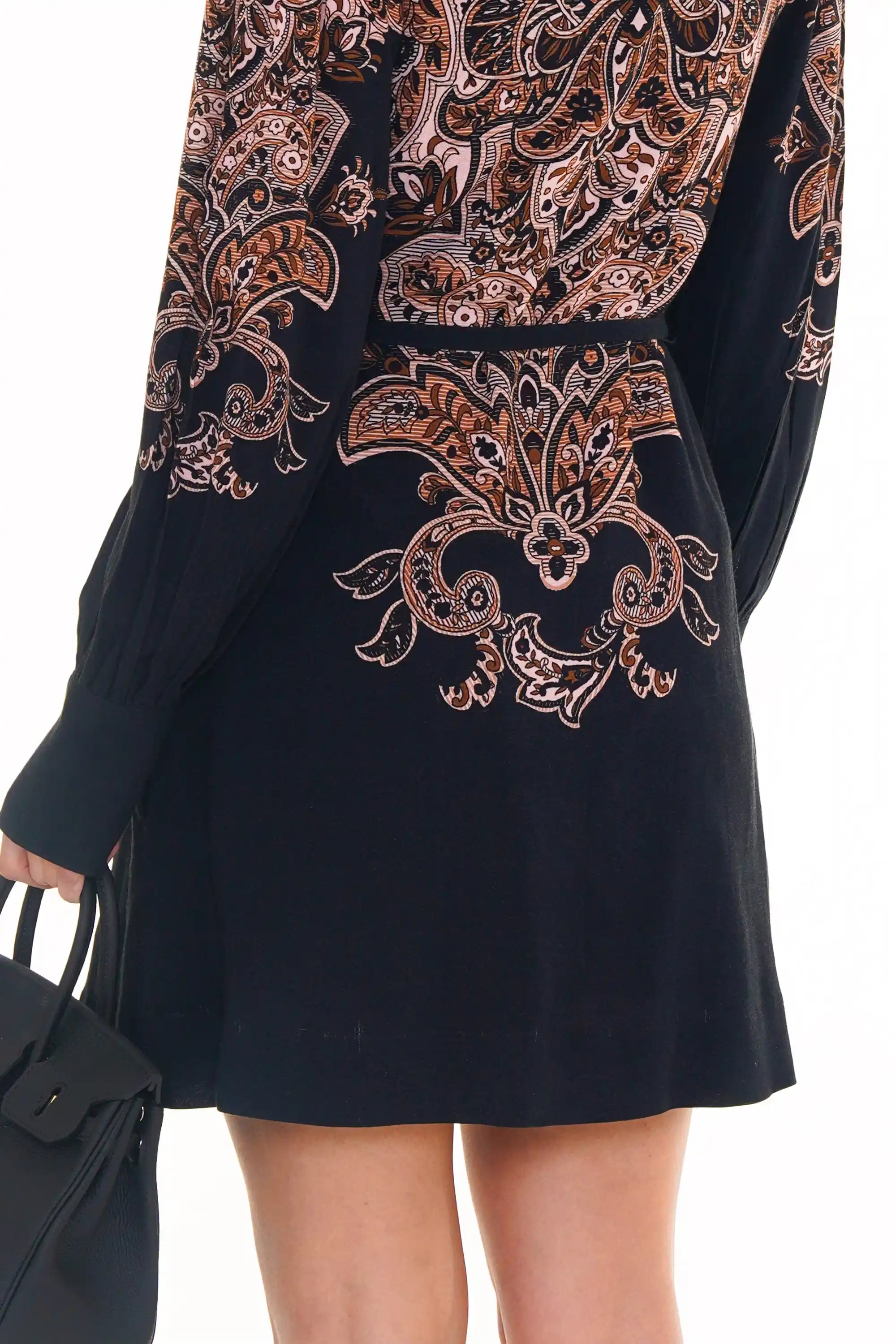 Back view of navy ornate printed mini dress with long sleeves