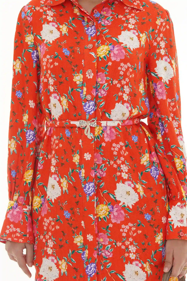 Close-up of Pretty Pixie orange multicolor floral belted collared shirt dress with crystal bow buckle