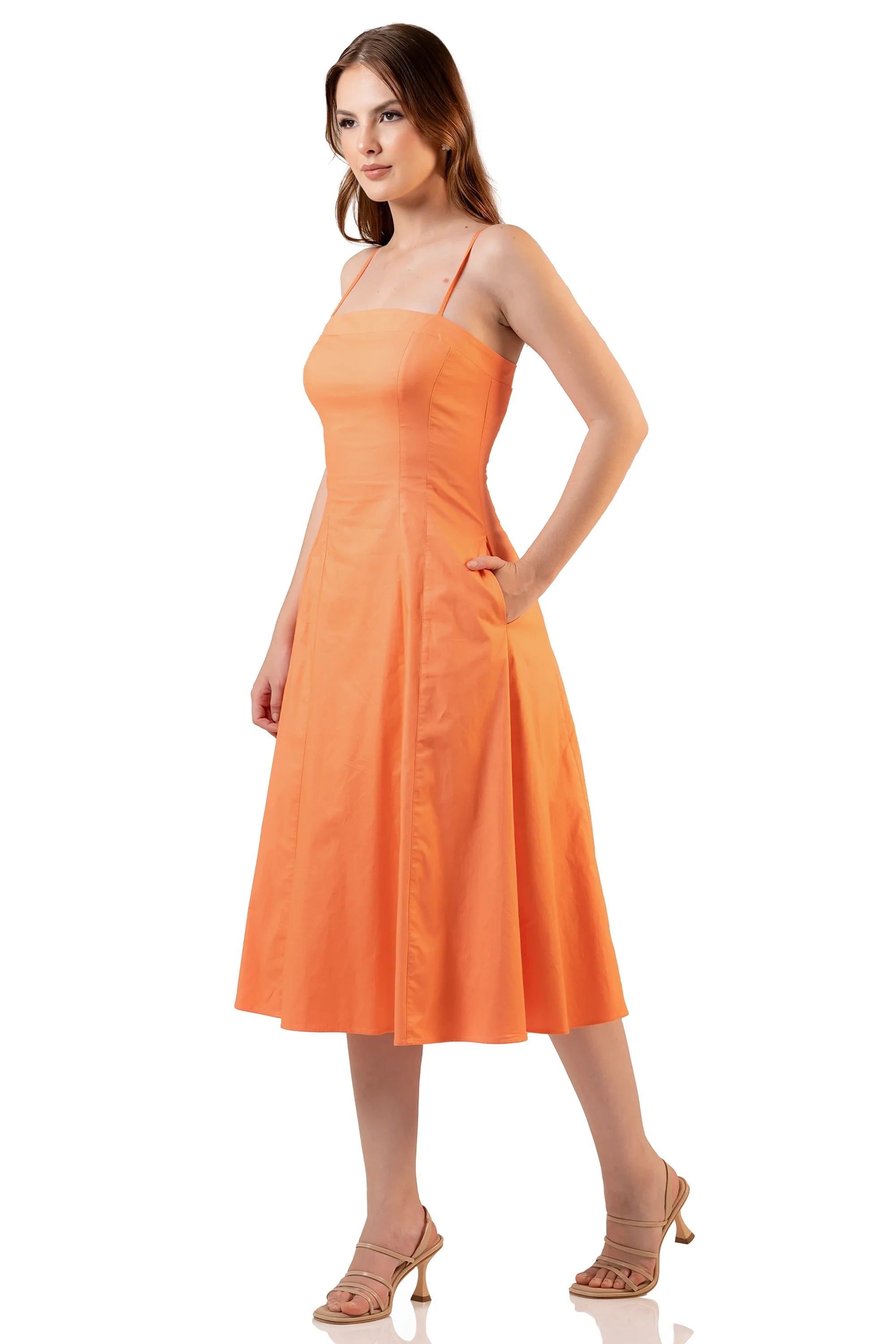 Side view: orange spaghetti strap midi dress with flared hem and pockets