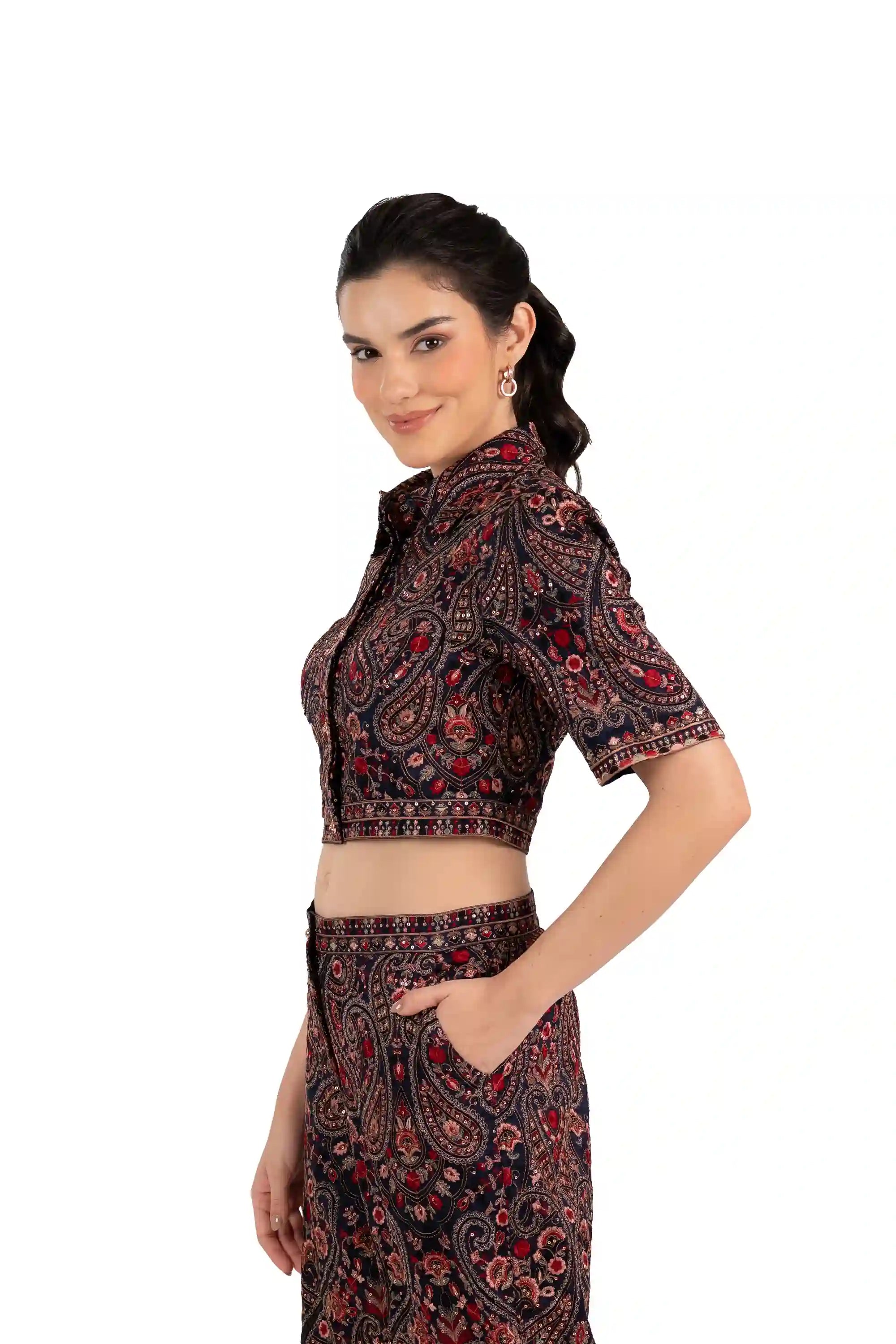 Side profile of woman wearing paisley print cropped collared top and matching pants, ethnic Indian fashion