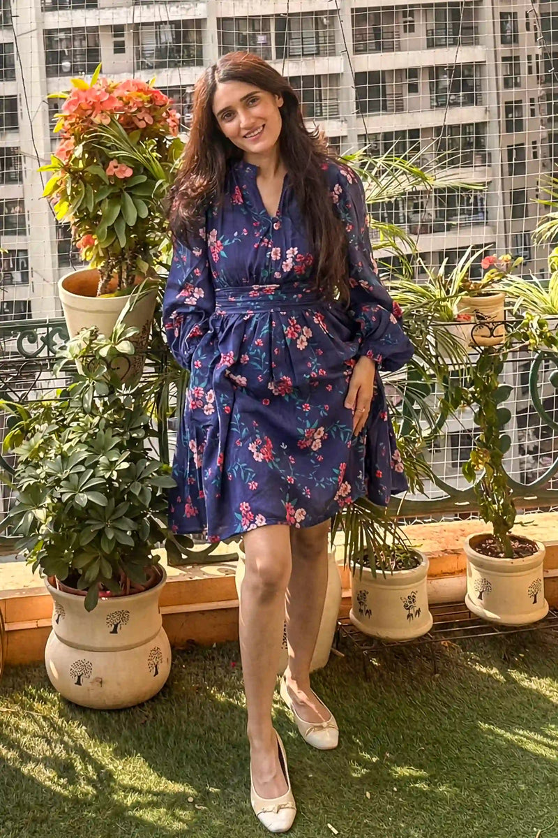 Pankhuri wearing navy floral long sleeve mini dress outdoors