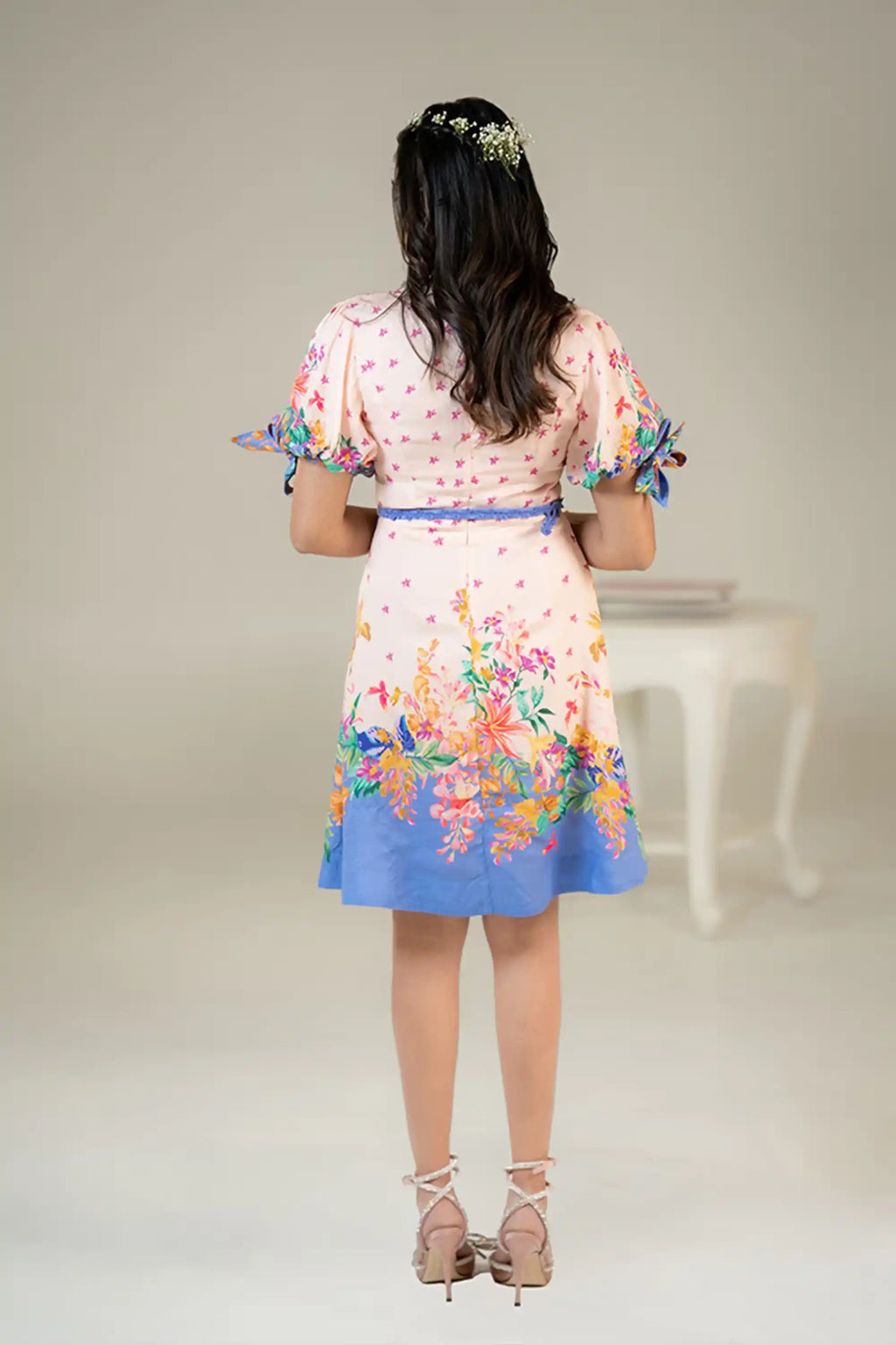 Back view of pastel pink floral dress with blue border hem