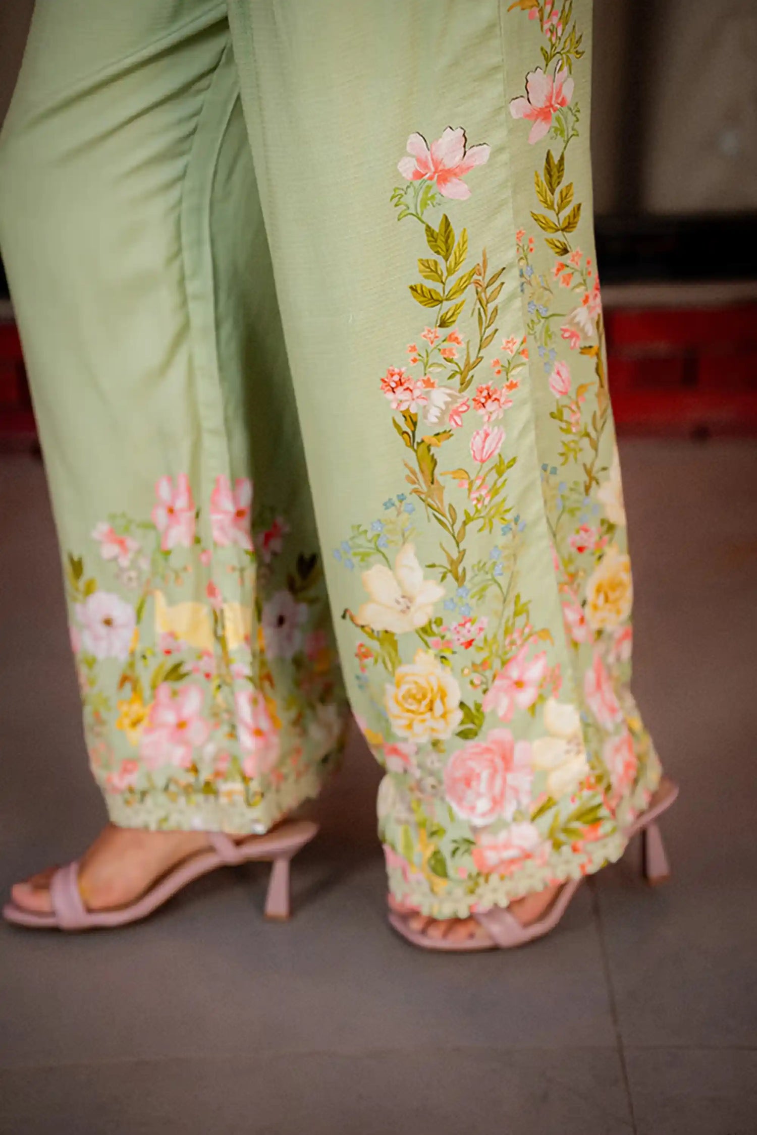 Hemline floral embroidery detail on pastel green wide leg pants