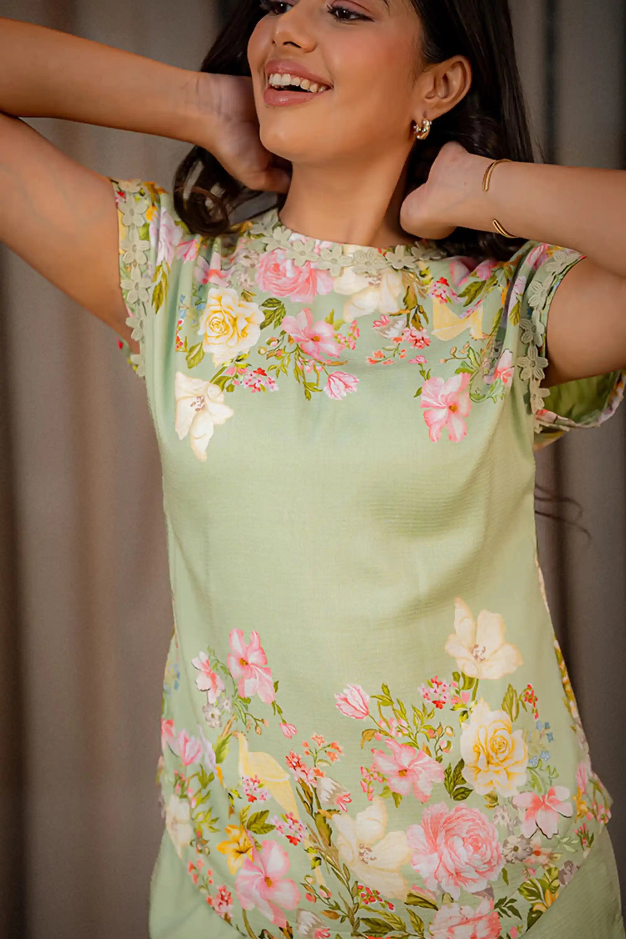 Closeup of pastel green floral coord set top with neckline flower embroidery