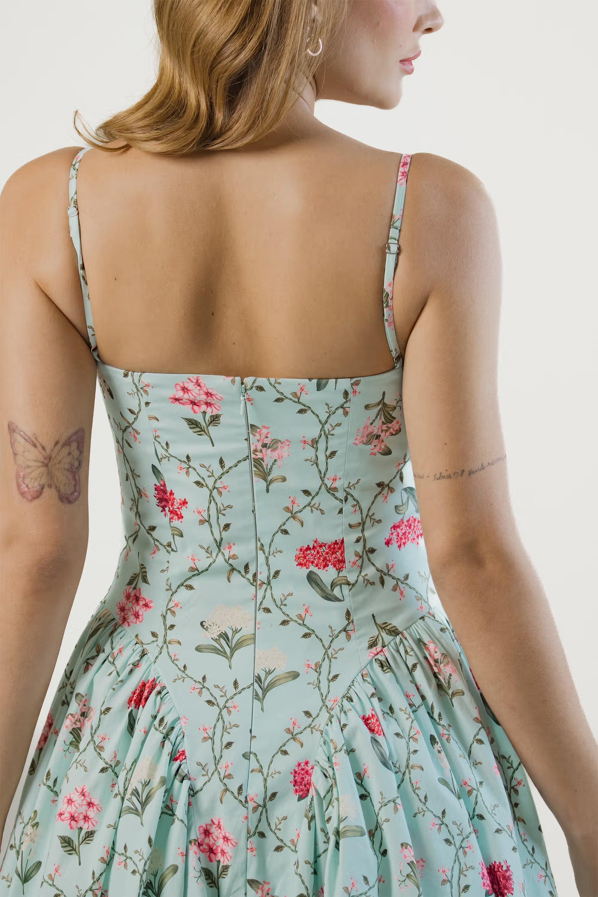 Pastel green floral midi dress, back view, flared skirt, pink flower print.