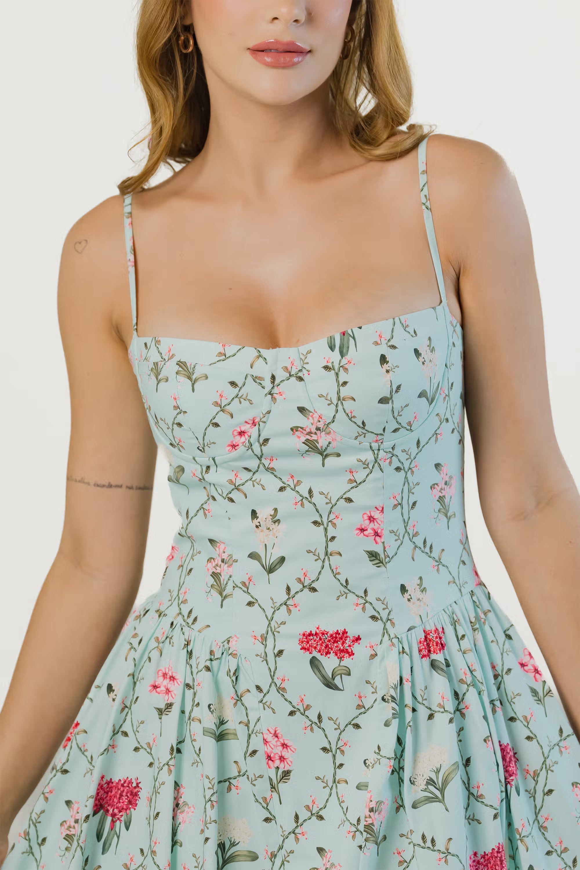 Pastel green floral dress, close-up of fitted bodice and thin straps.