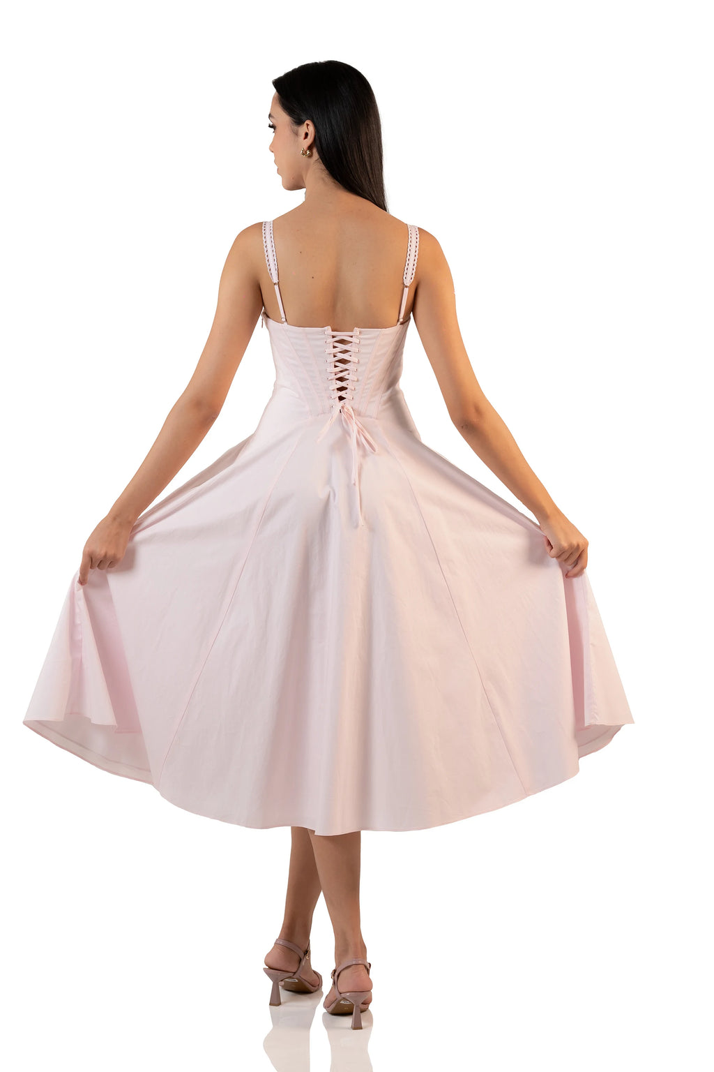 Back view of pastel pink bustier midi dress with lace-up corset back and flared A-line skirt spread