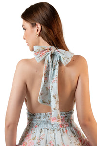Closeup of back bow tie on pastel floral halter mini dress with ruffle tiers