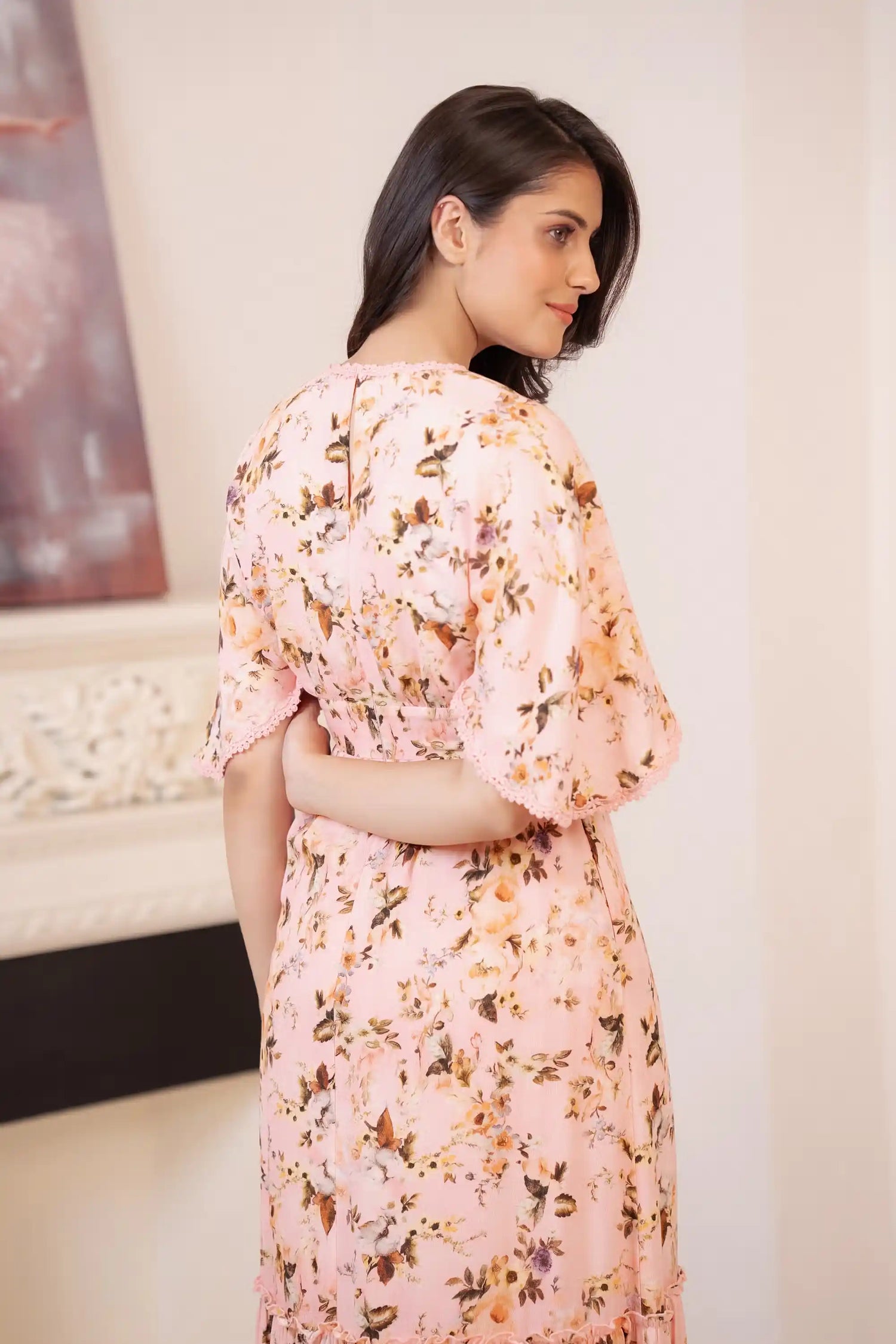 Back view of peach pink floral maxi dress with lace detail on sleeves