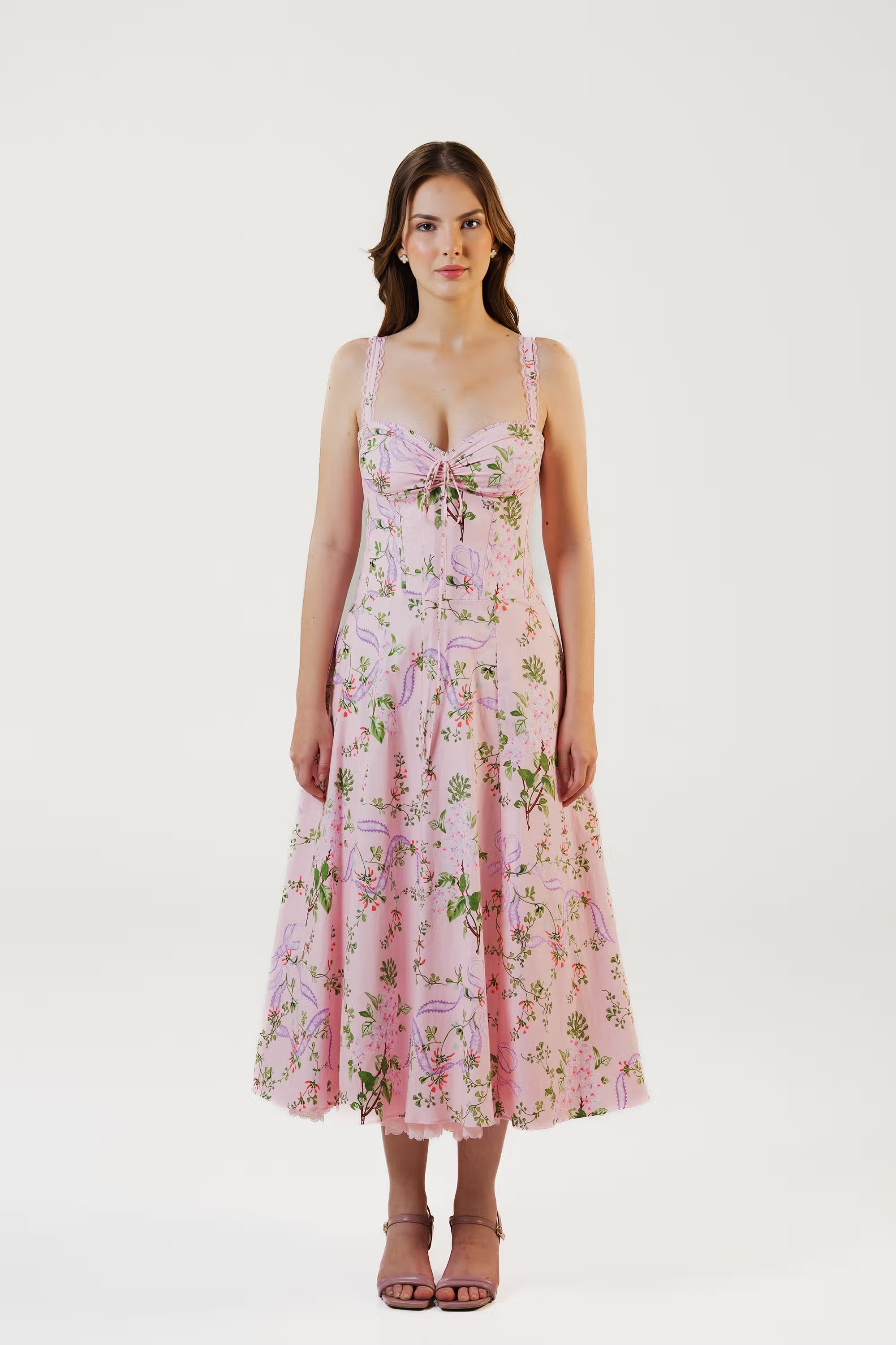 Woman wearing pink floral corset midi dress with fitted bodice and flared skirt, front view