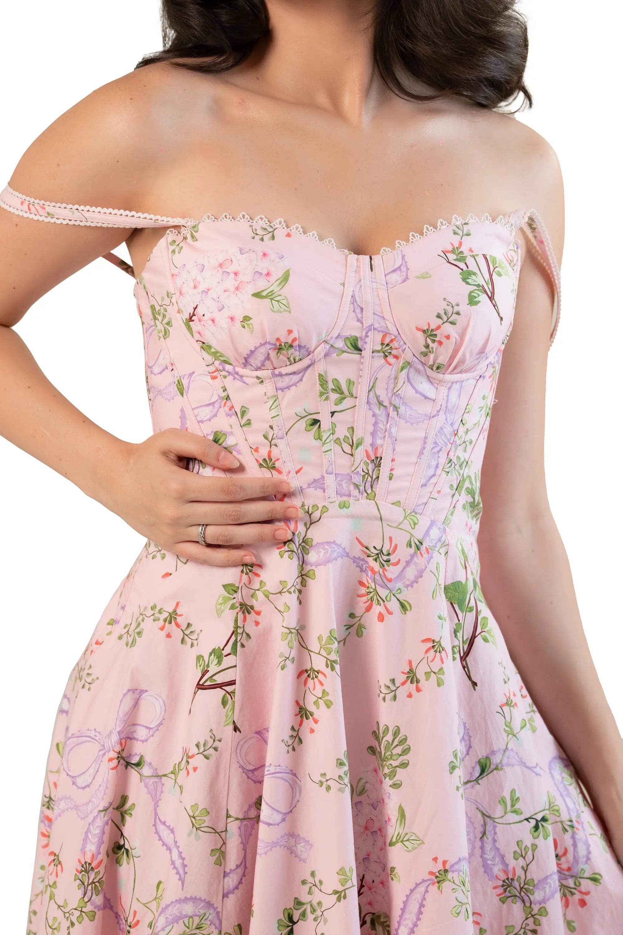 Pink floral corset midi dress styled off-shoulder — sweetheart bustier bodice with lace-trim straps, close-up