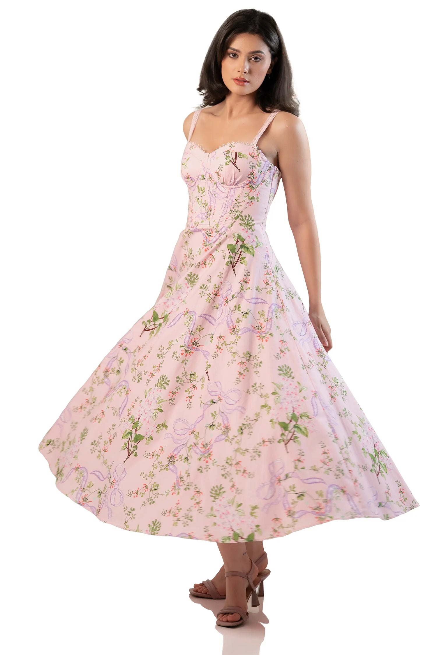 Side twirl view of pink floral corset midi dress with sweetheart neckline and flowing A-line skirt
