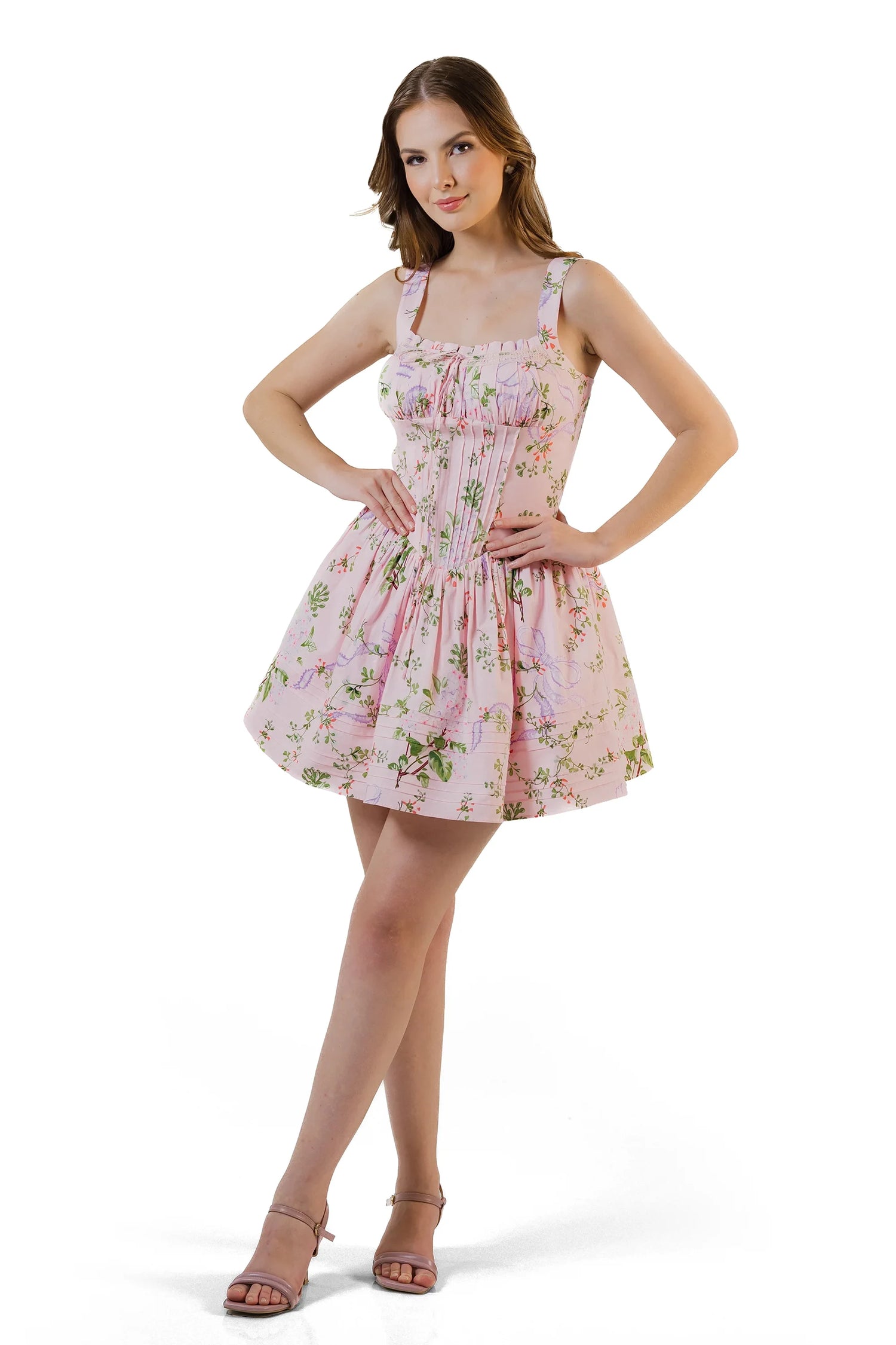 Model posing with hands on waist in pink floral corset mini dress – flattering fit and flare style.