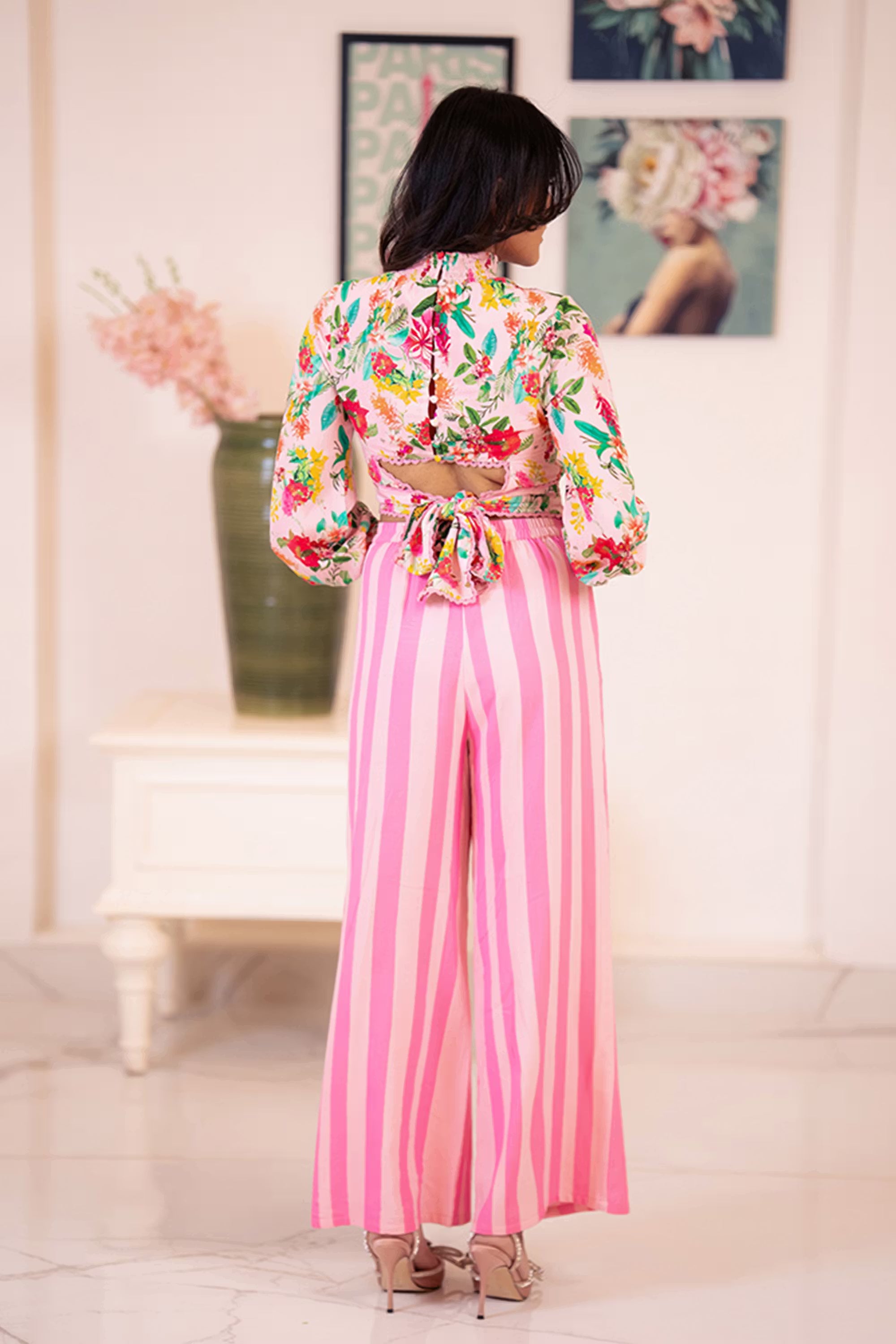Back view of pink floral crop top and striped pants co-ord