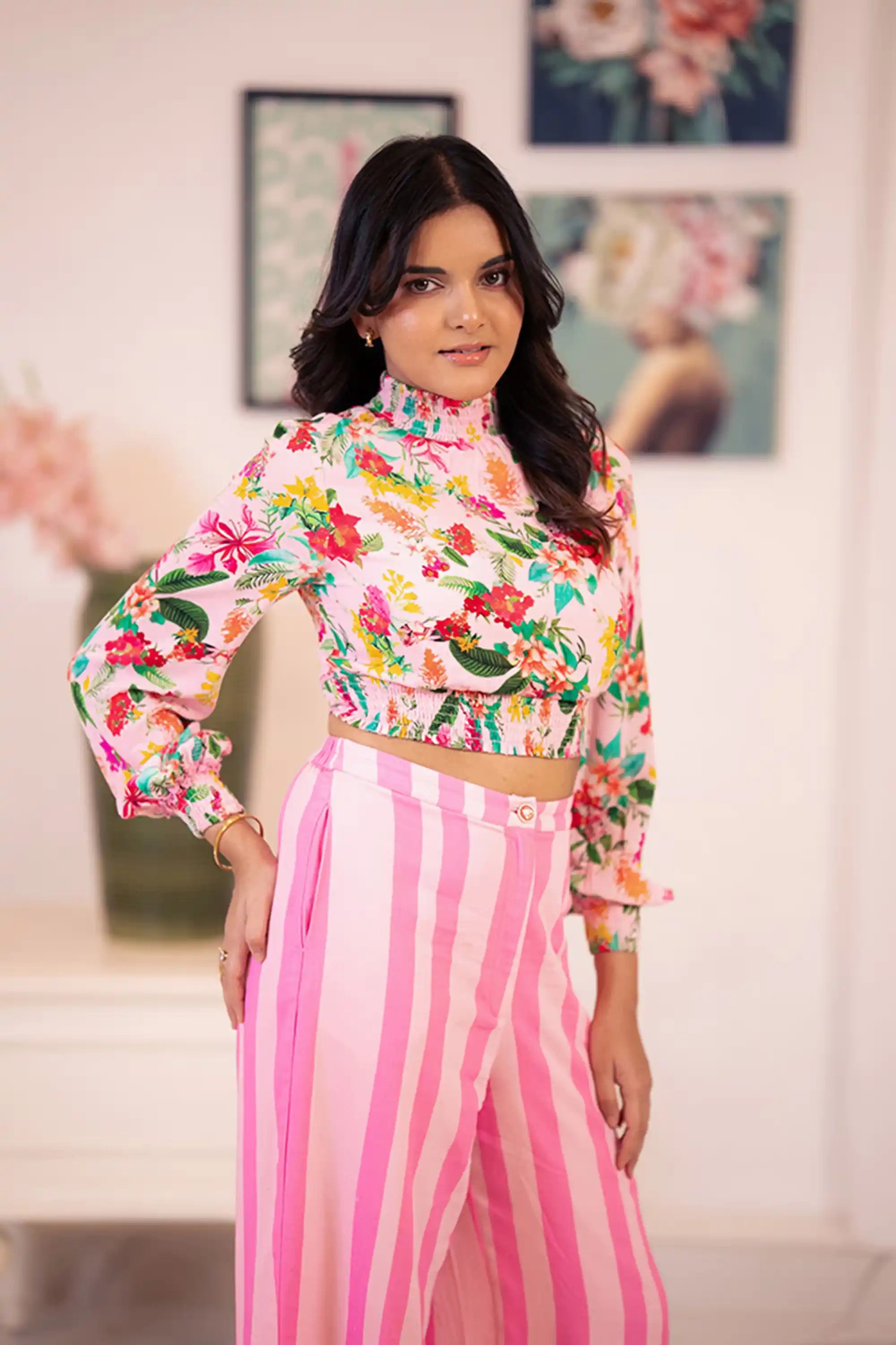 Pink floral crop top with pink striped pants side view