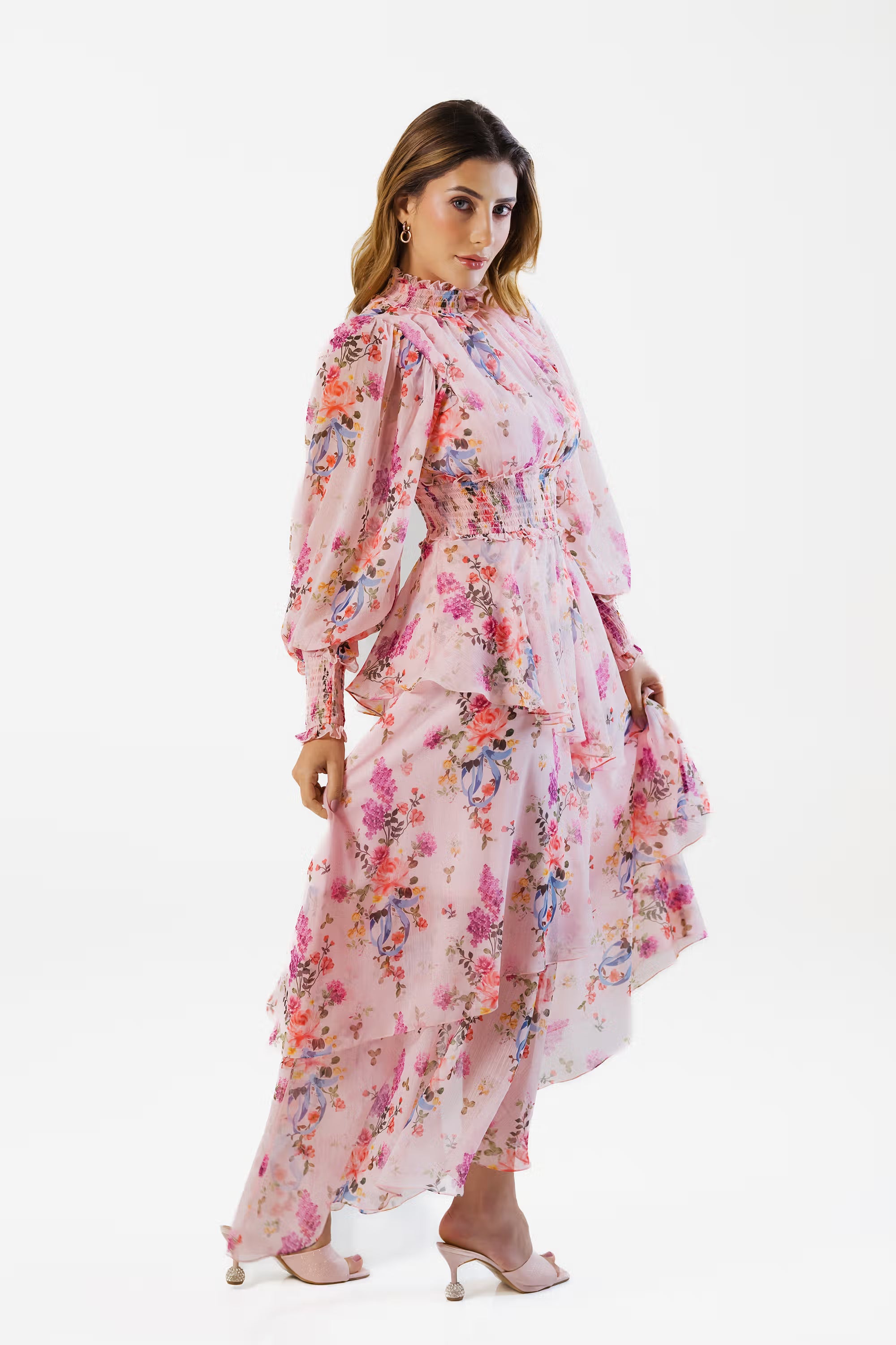 Side view of pink floral maxi dress with ruffled layers and smocked waist