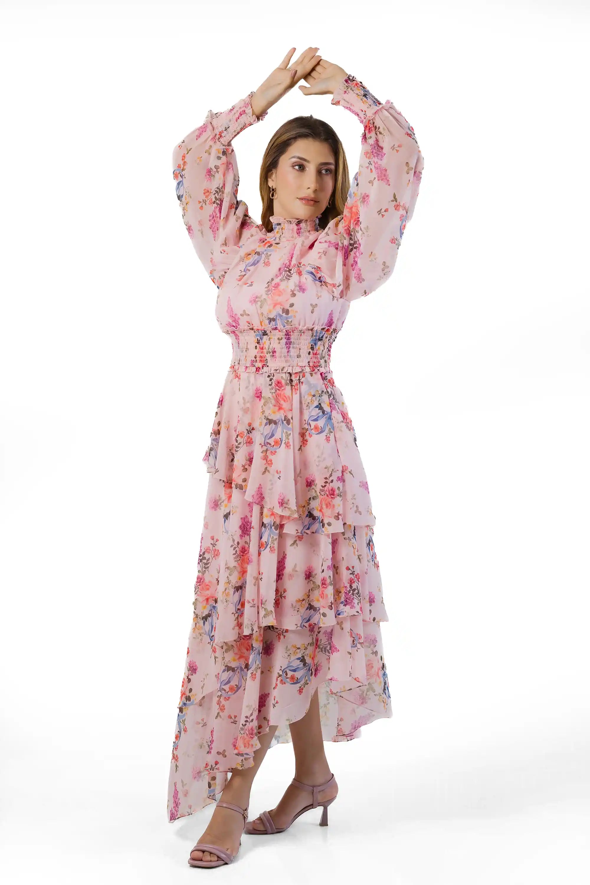 Arms-up pose in pink floral high-neck tiered maxi showing flowy sleeves