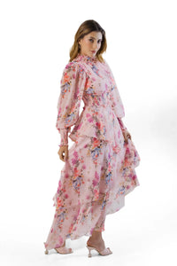 Side angle view: pink floral high-neck tiered maxi with asymmetric tiers