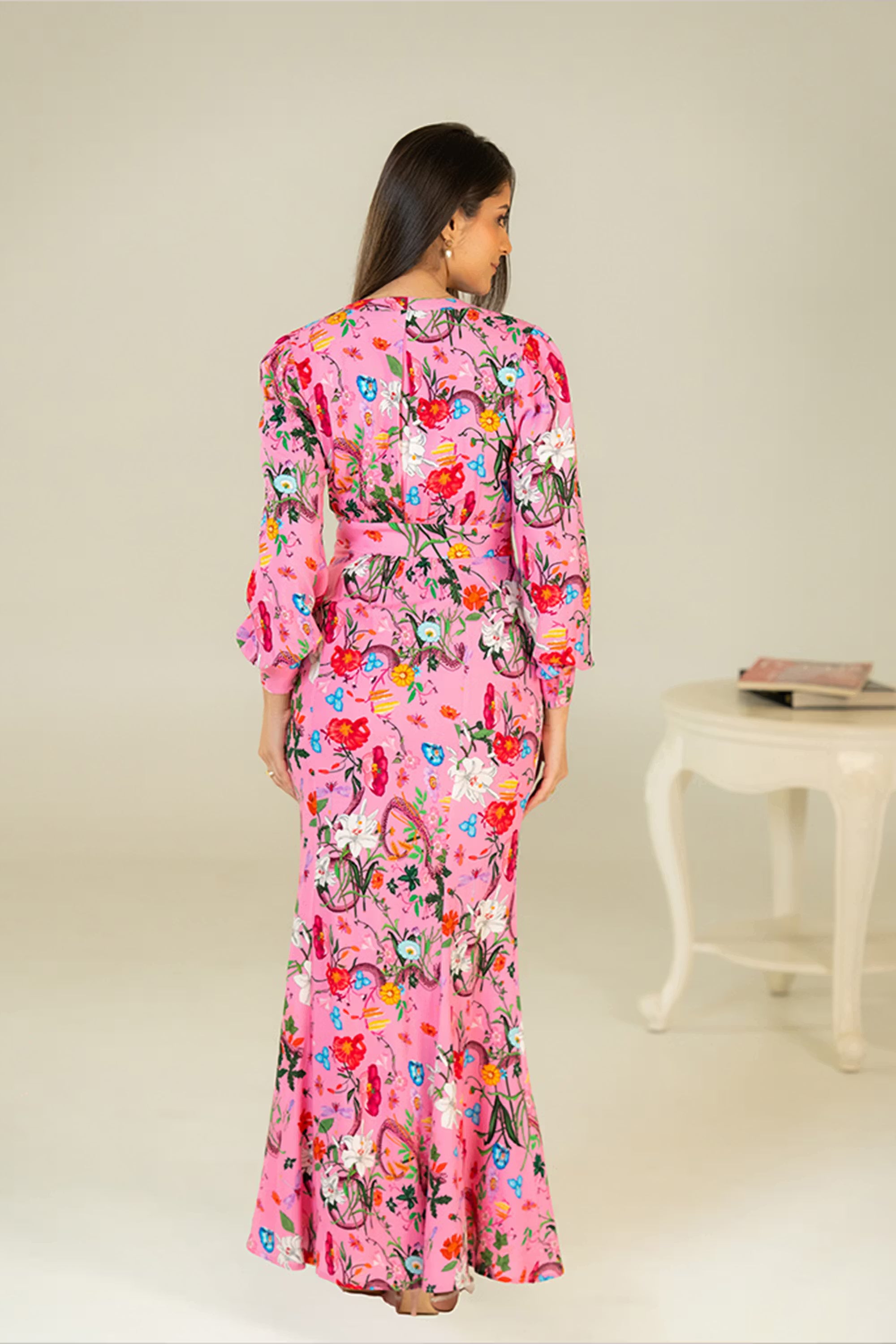 Back view of pink maxi dress with multicolor floral print and long sleeves