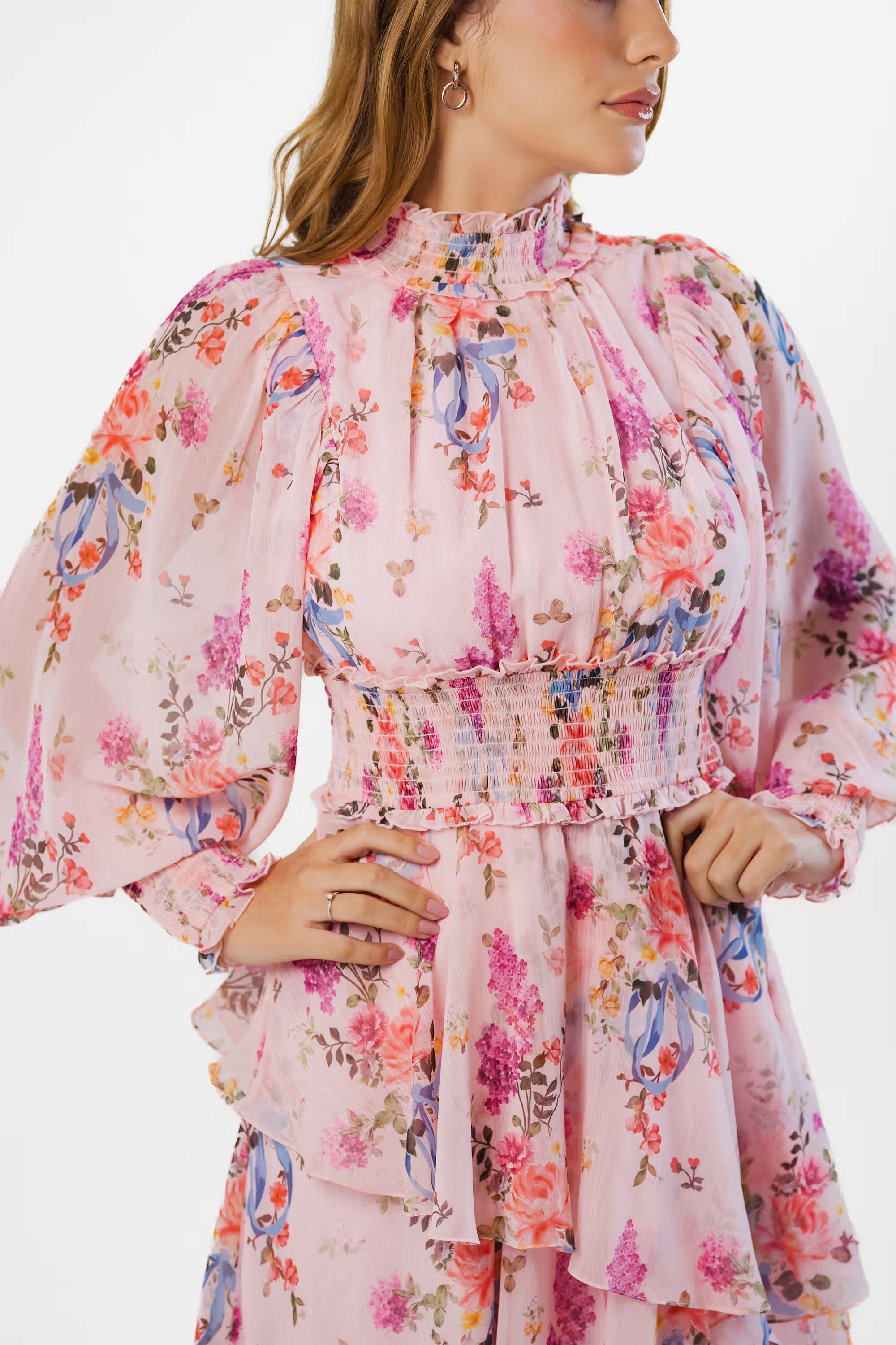 Detailed view of smocked waist and puff sleeves on pink floral maxi dress