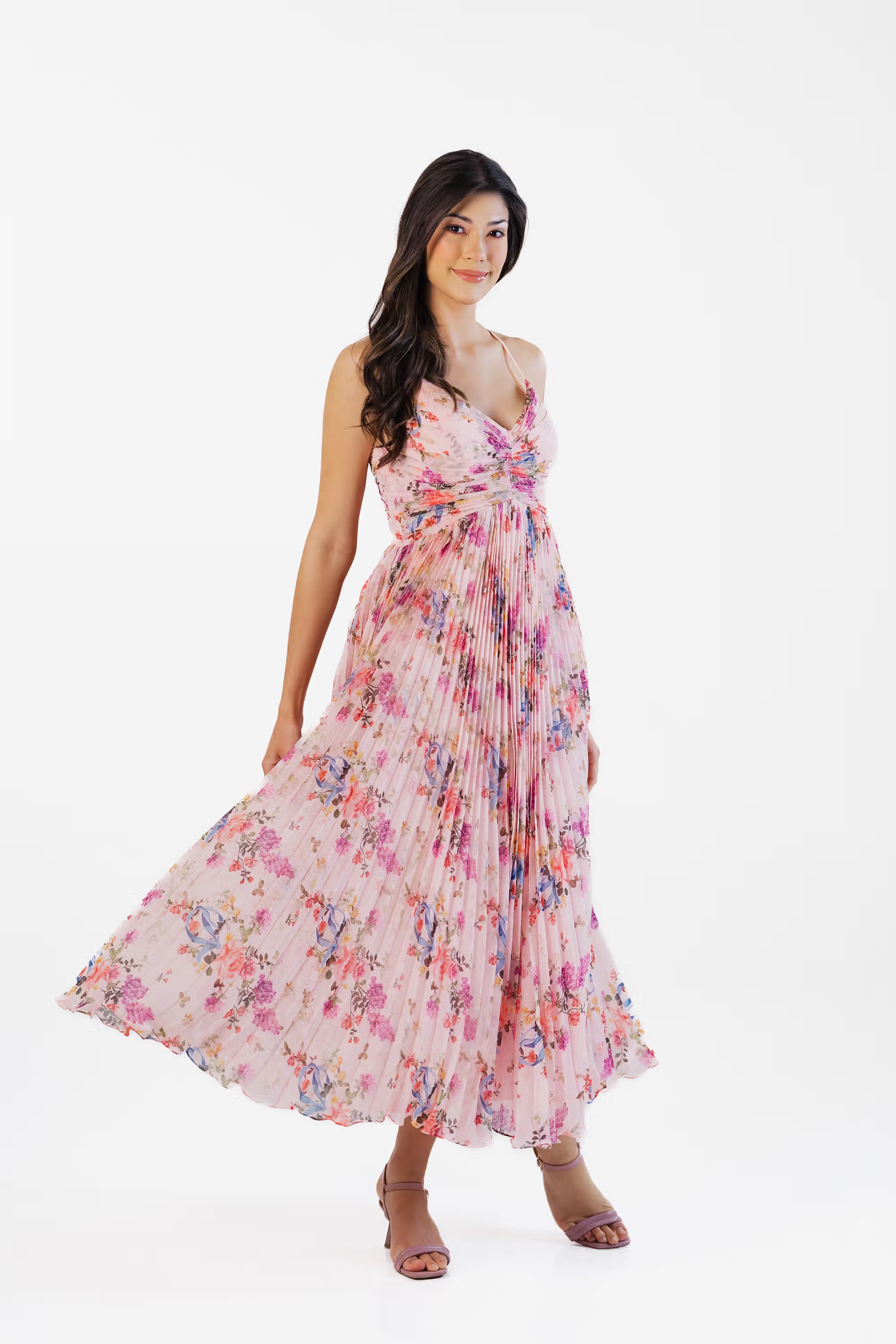 Full-length front view of pink floral pleated maxi dress with flowy hem and flattering fit.