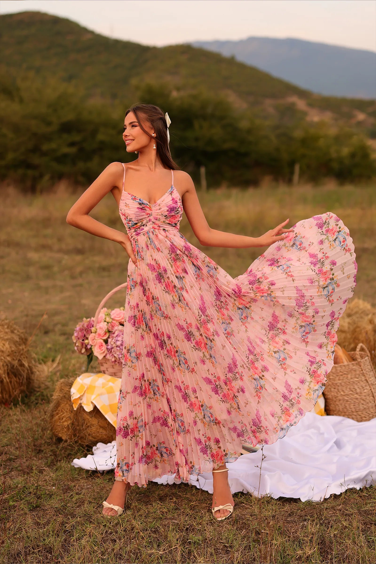 Indian woman in pink pleated floral maxi dress at picnic, summer outdoor garden fashion, India 2025.
