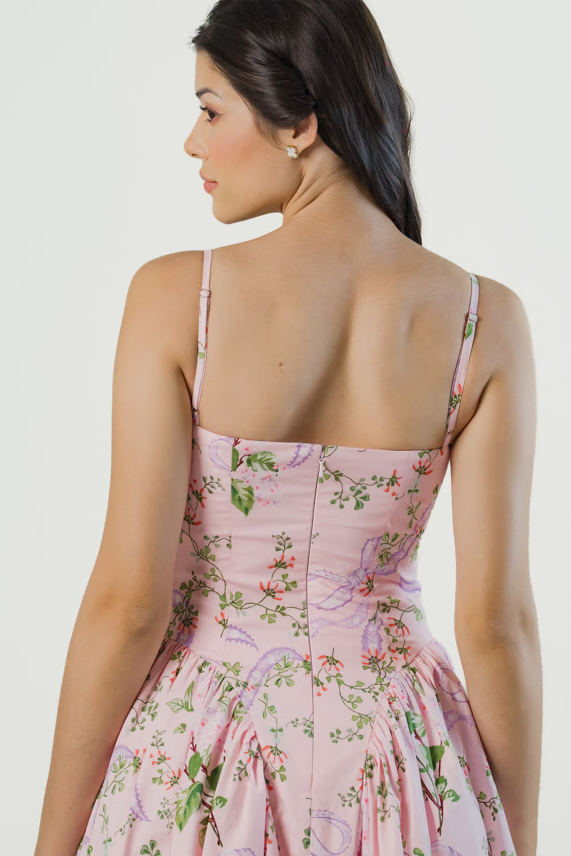 Back view of spaghetti strap pink floral midi dress with zipper bodice and flared hemline.