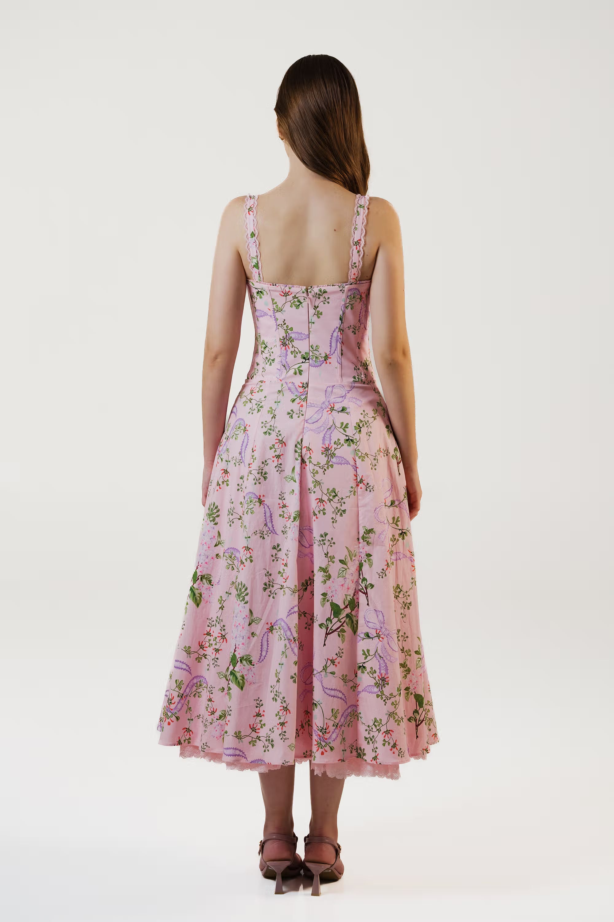 Back view of pink floral corset midi dress with zipper closure and flared hemline