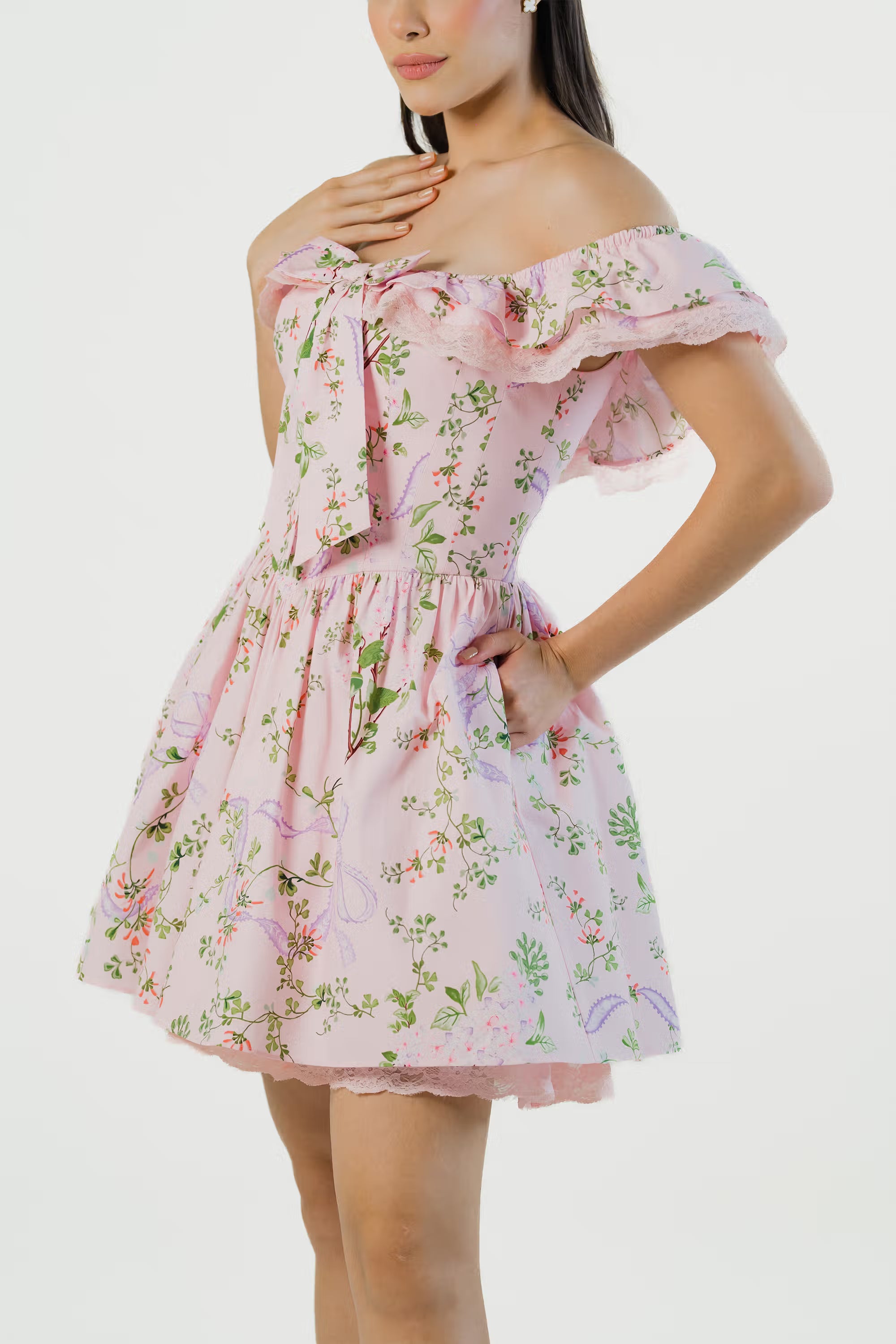 Pink floral mini dress with lace trim and bow tie showing detailed floral print