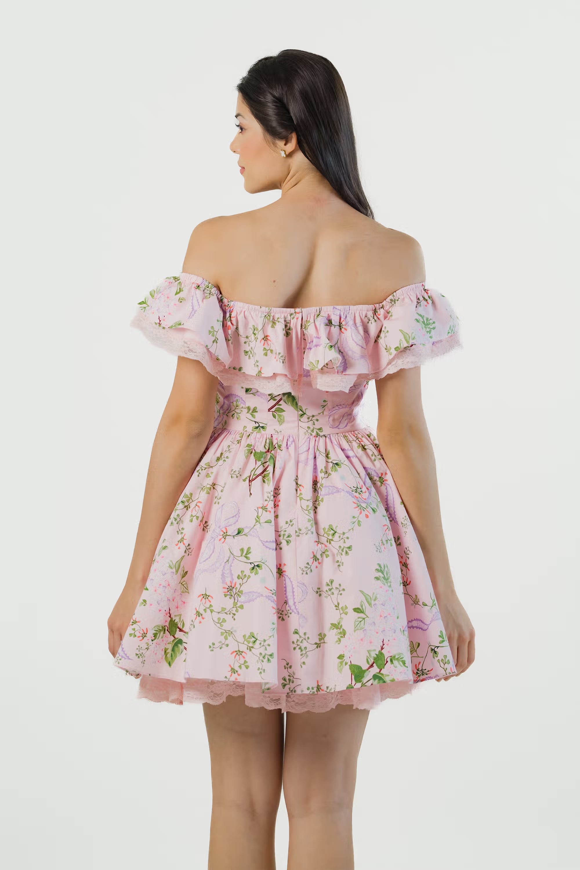 Back view of pink floral off shoulder mini dress with ruffle neckline and lace hem