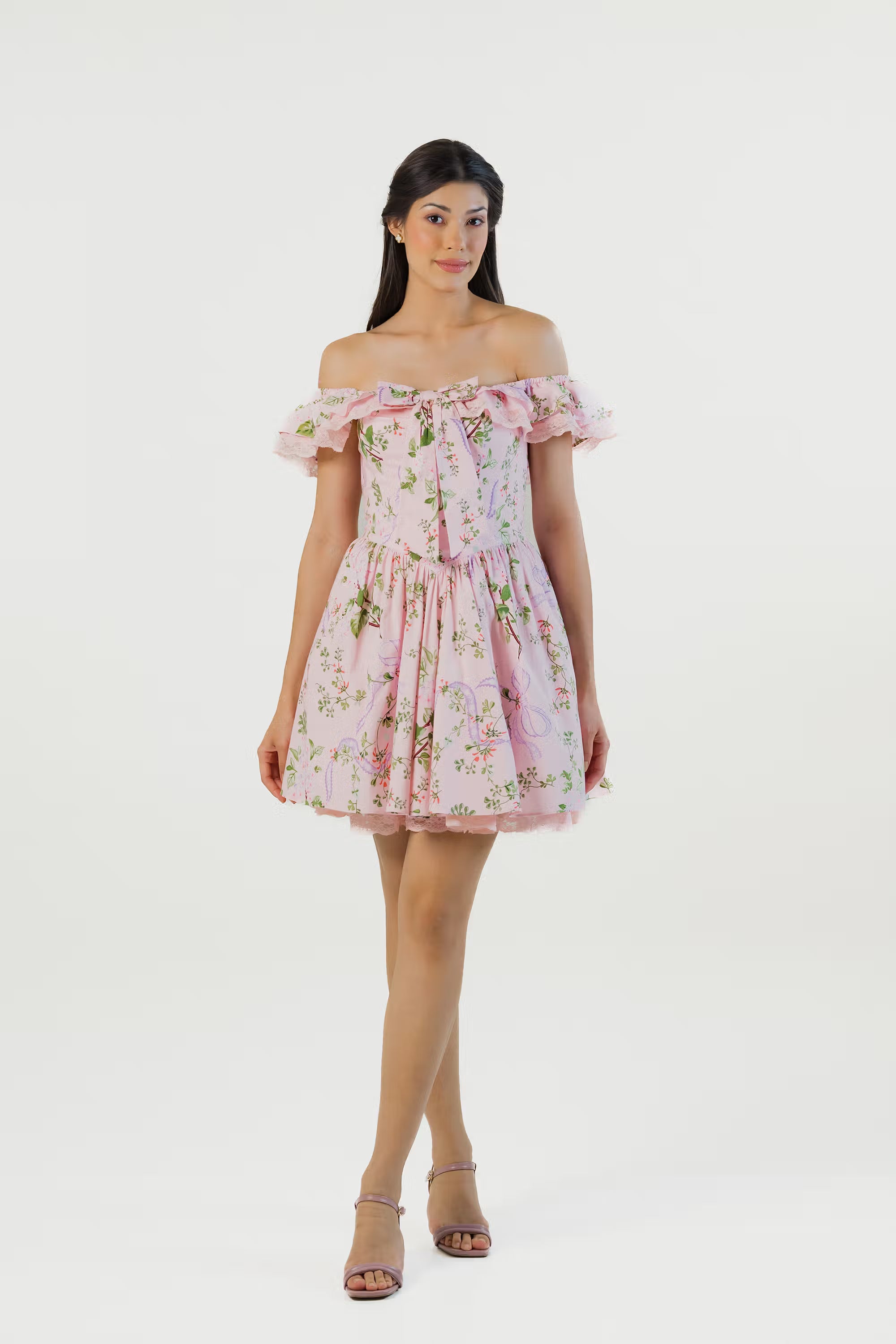 Front view of pink floral off shoulder mini dress with bow detail and lace trim