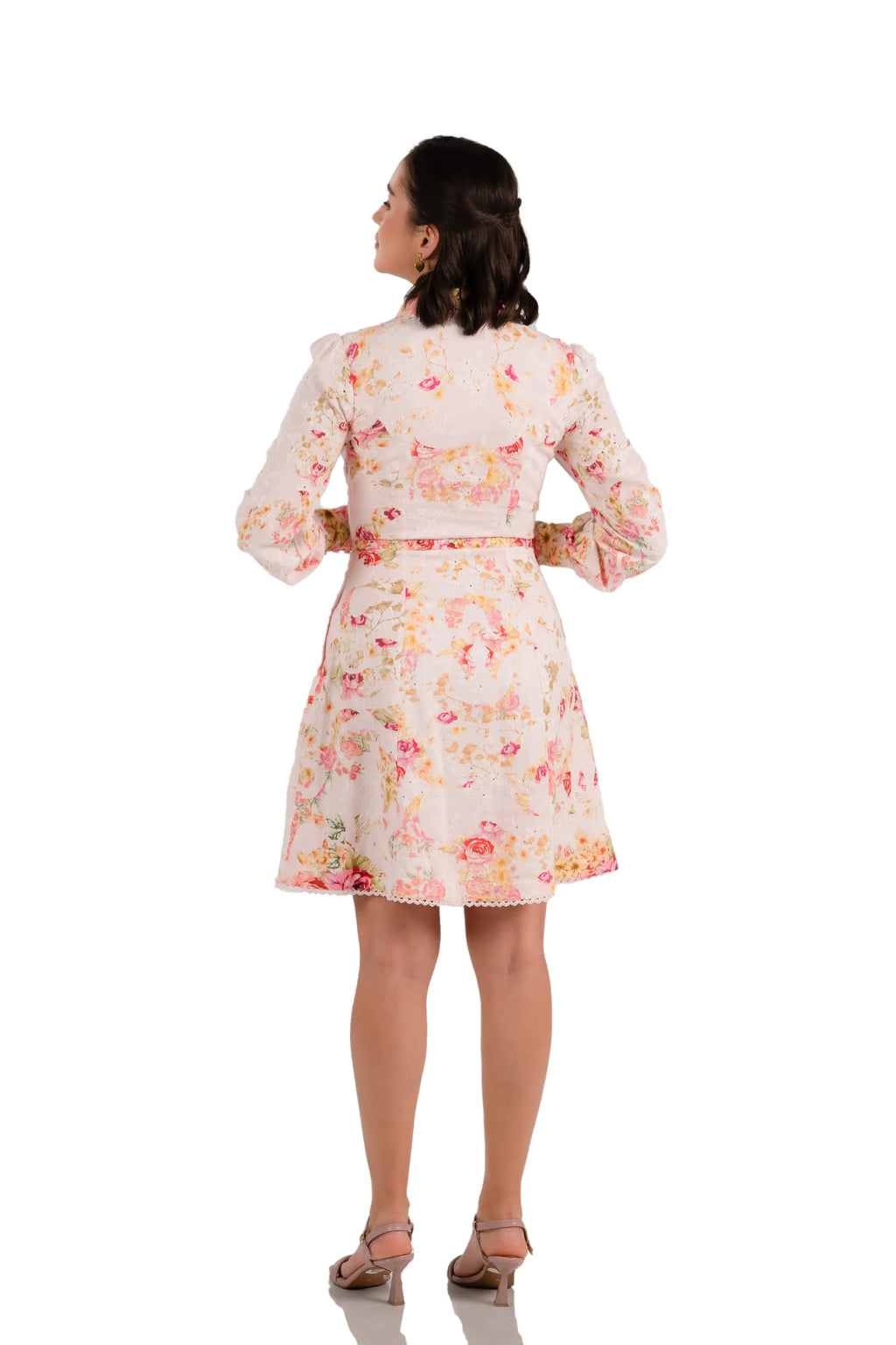 Back view of pink floral print collared mini dress with belt and long sleeves
