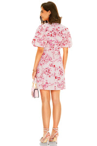 Back view of pink floral mini dress with puff sleeves and floral print