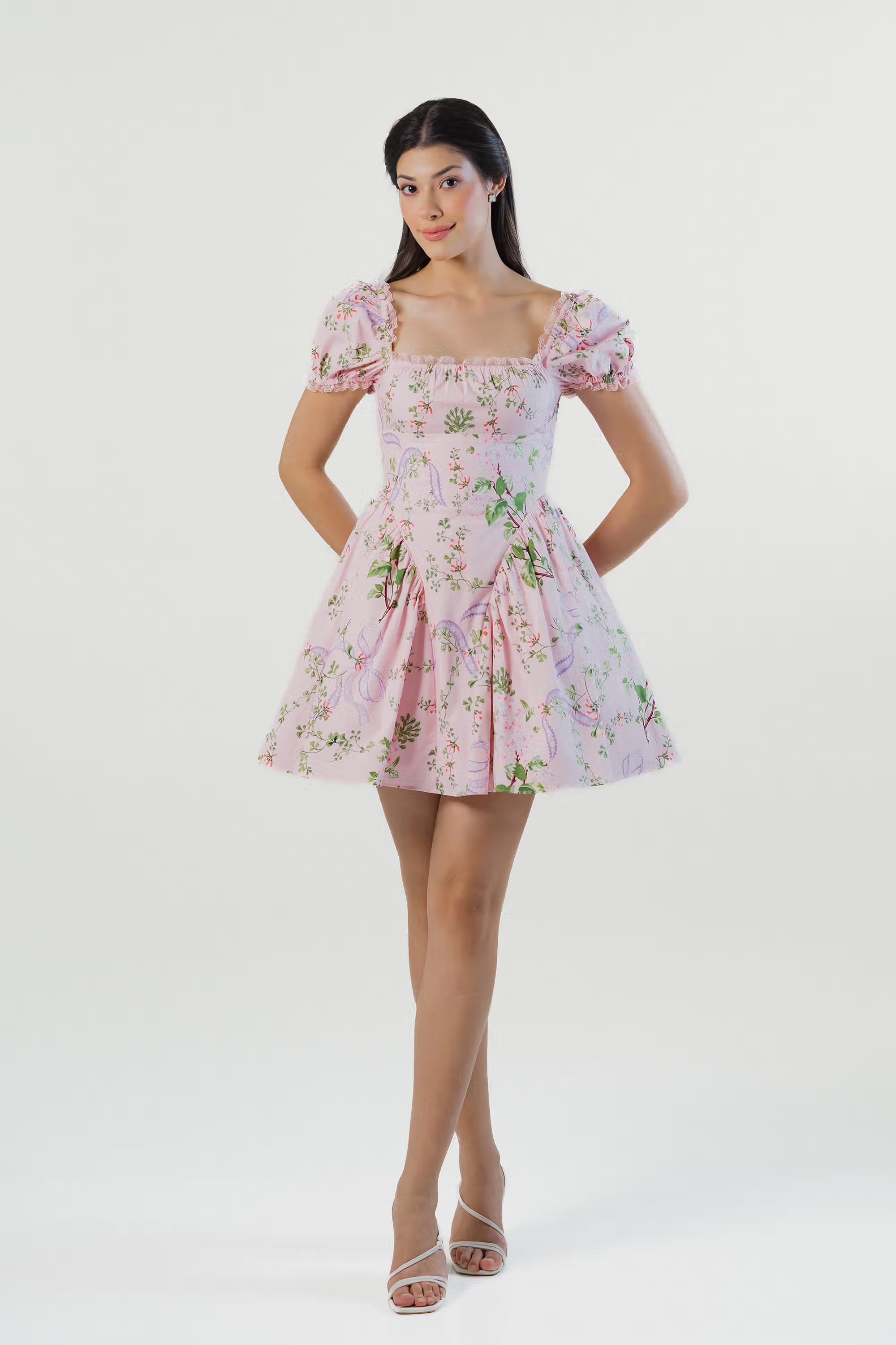 Front view of a pink puff sleeve floral mini dress with square neckline and flared skirt.