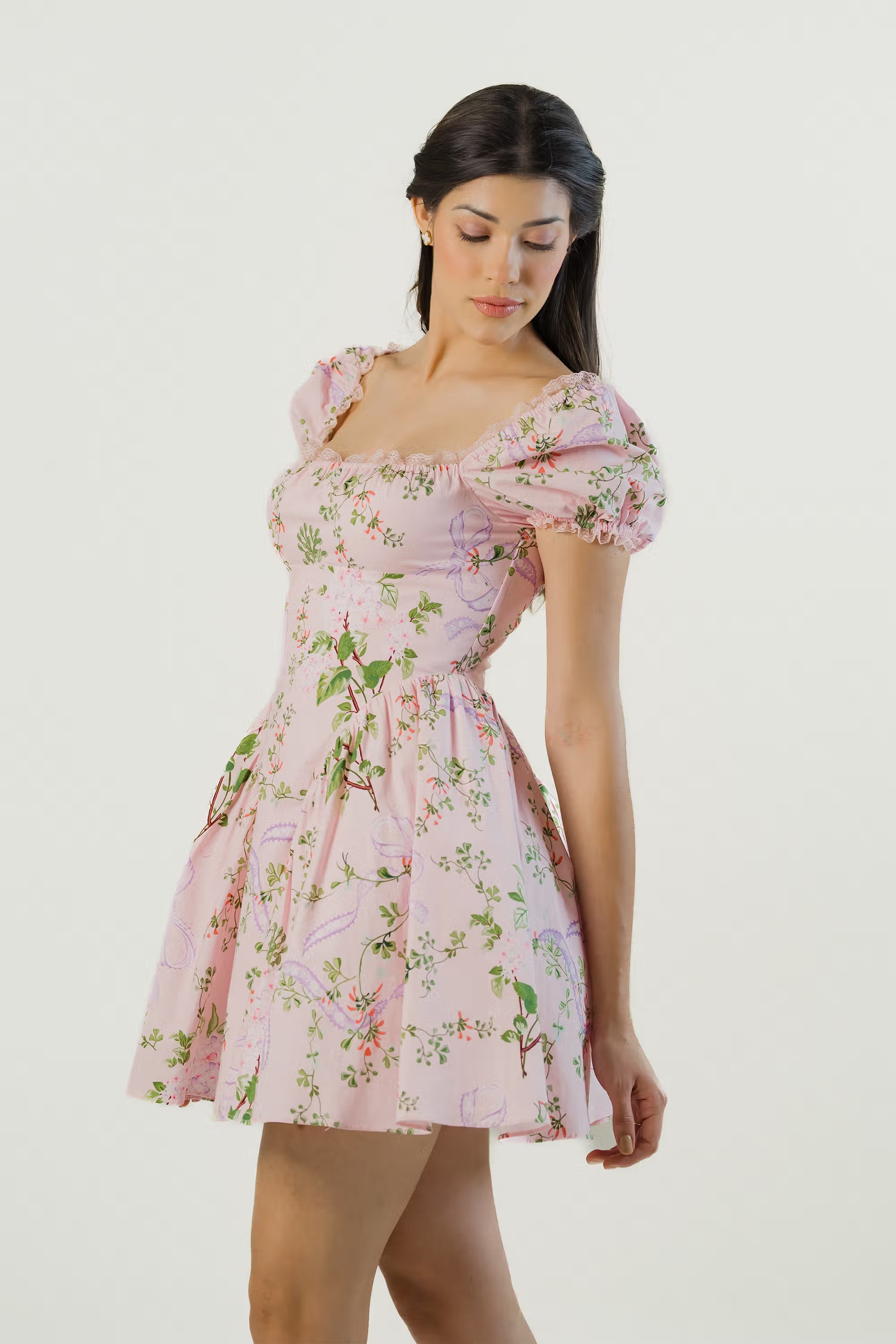 Side profile of pink floral puff sleeve short dress showing elegant fit and flared hem.