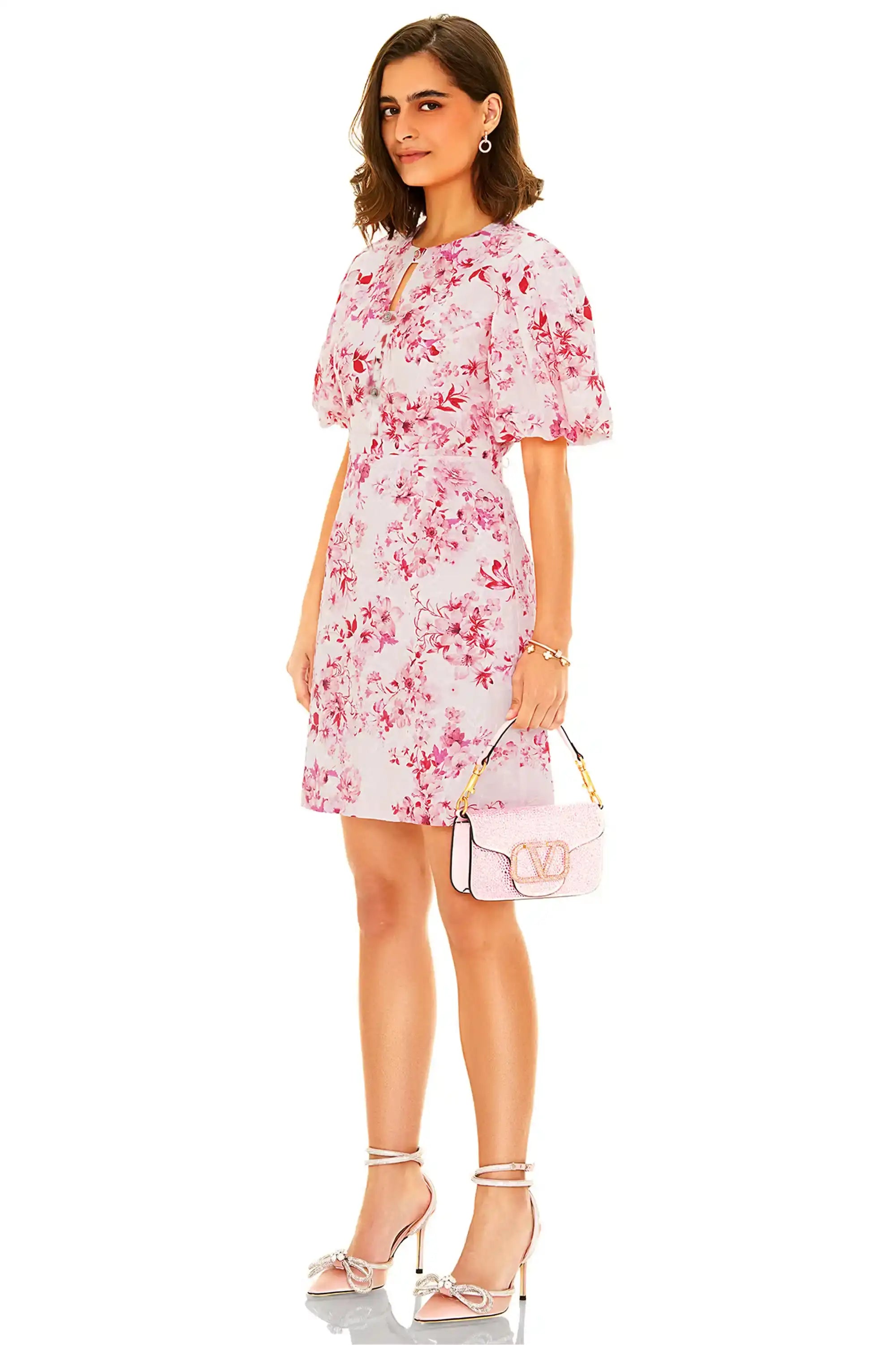 Side profile of pink floral puff sleeve mini dress with fitted waist