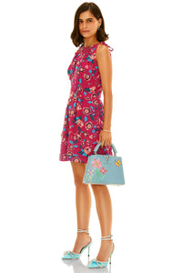 Side view of pink floral sleeveless mini dress with belt, summer fashion outfit