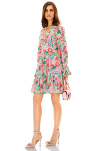 Side view of pink floral V-neck long sleeve mini dress with flared hem