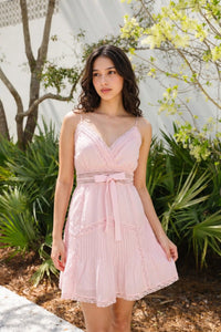 Full view of pink silk mini dress with v-neck lace trim pleated skirt beaded waist casual elegant