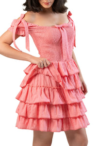 Ruffle skirt close-up on pink smocked off-shoulder mini dress