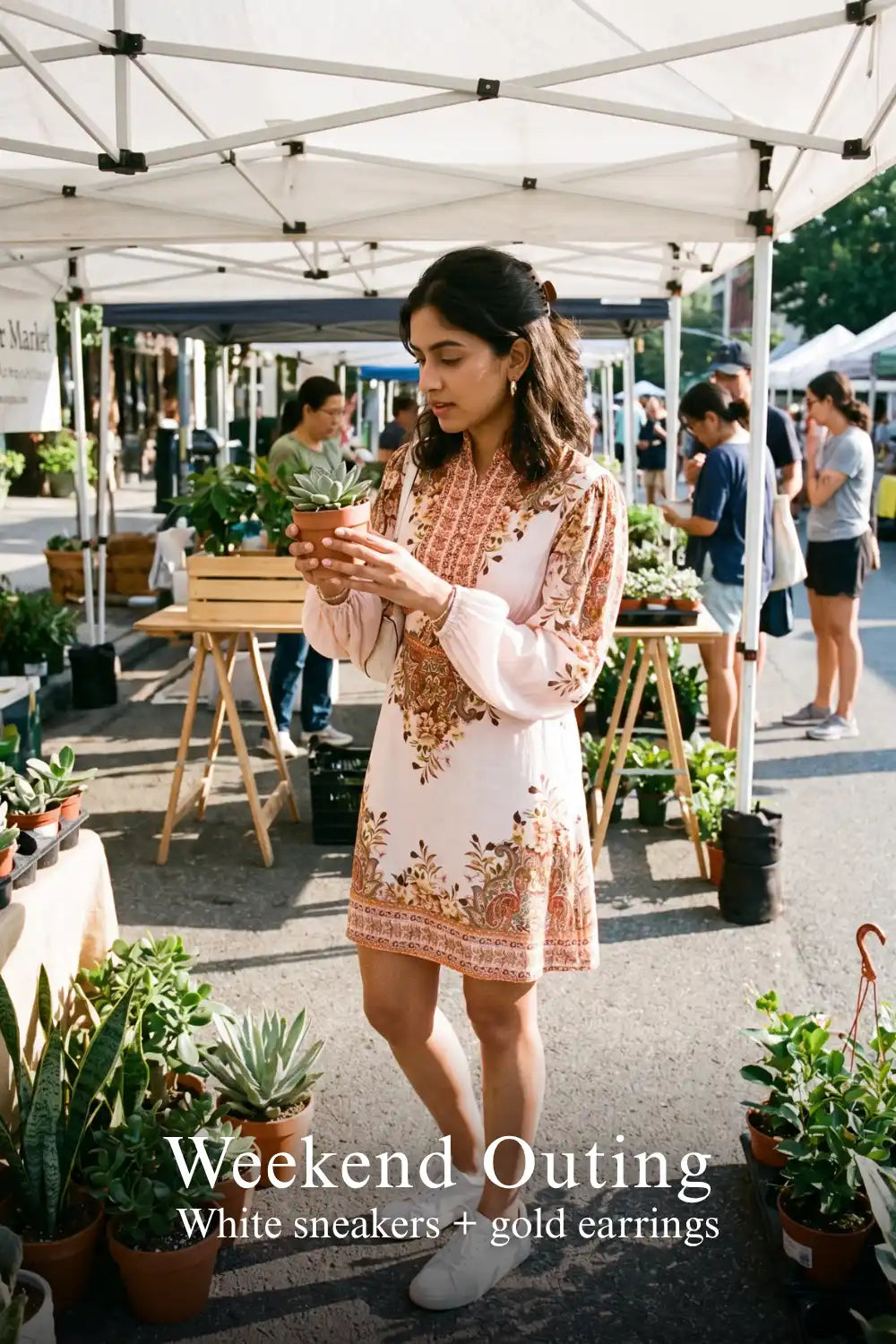 Woman in Pretty Pixie beige paisley puff-sleeve mini dress styled for a weekend market
