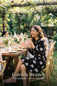 Woman in Pretty Pixie midnight iris floral belted long-sleeve mini dress styled for a garden brunch 3