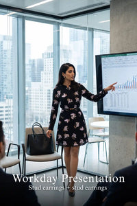 Woman in Pretty Pixie midnight iris floral belted long-sleeve mini dress styled for a workday presentation 2