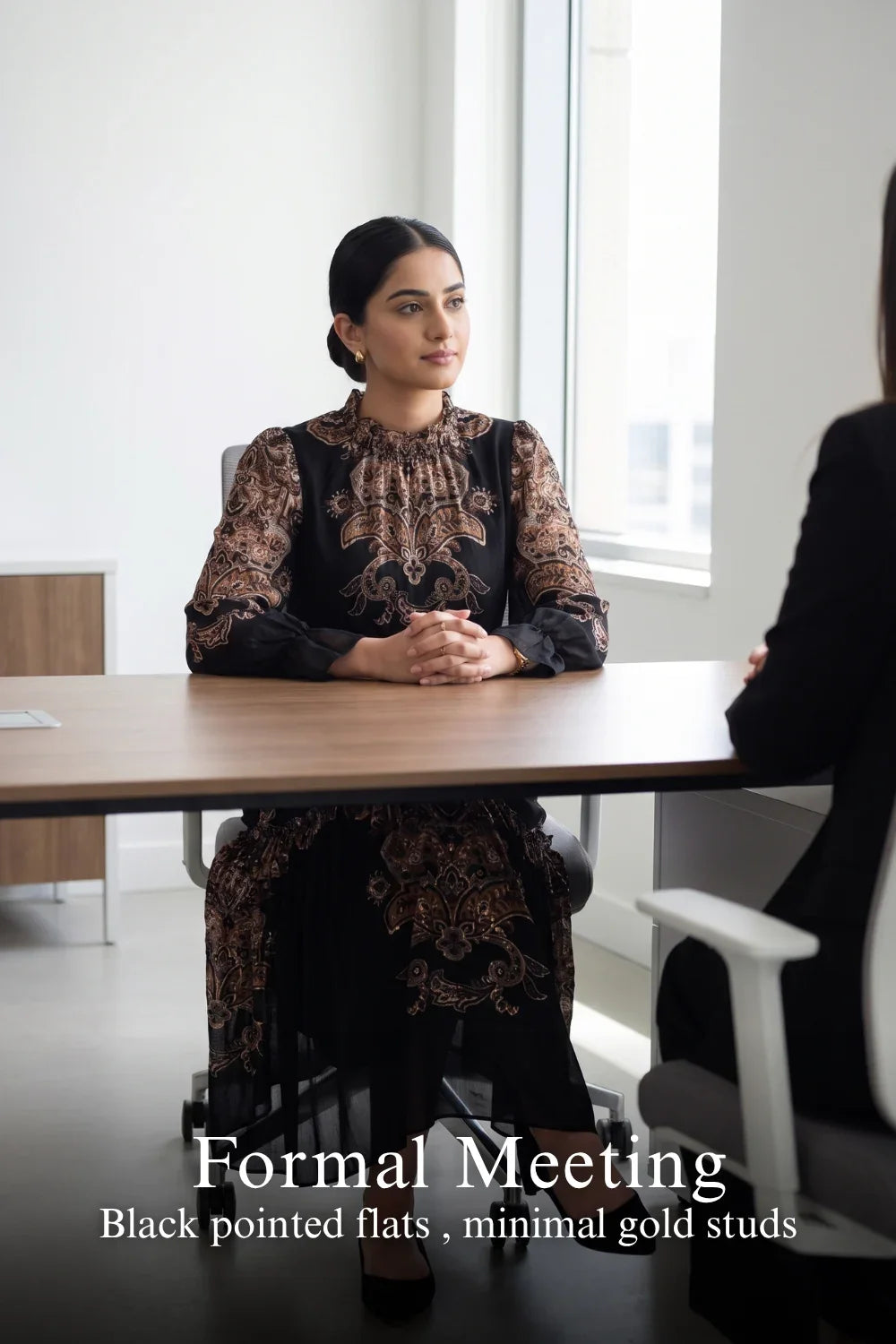 Woman in Pretty Pixie navy paisley kaitlyn tubular long-sleeve midi dress styled for a formal meeting