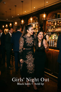 Woman in Pretty Pixie navy paisley kaitlyn tubular long-sleeve midi dress styled for a girls night out