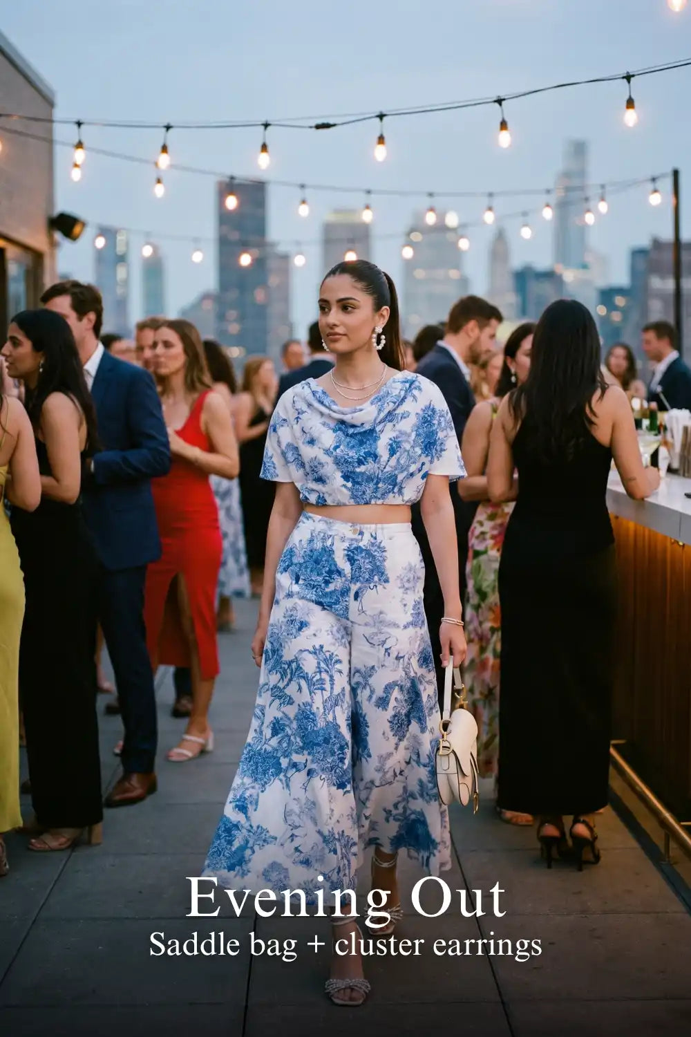 Woman in Pretty Pixie blue toile cowl crop top & palazzo pants co-ord set styled for an evening out 2
